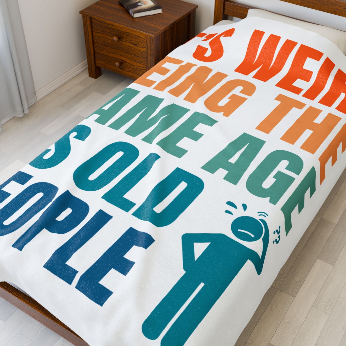 60X80 blanket with colorful text and graphic on a bed in a room.