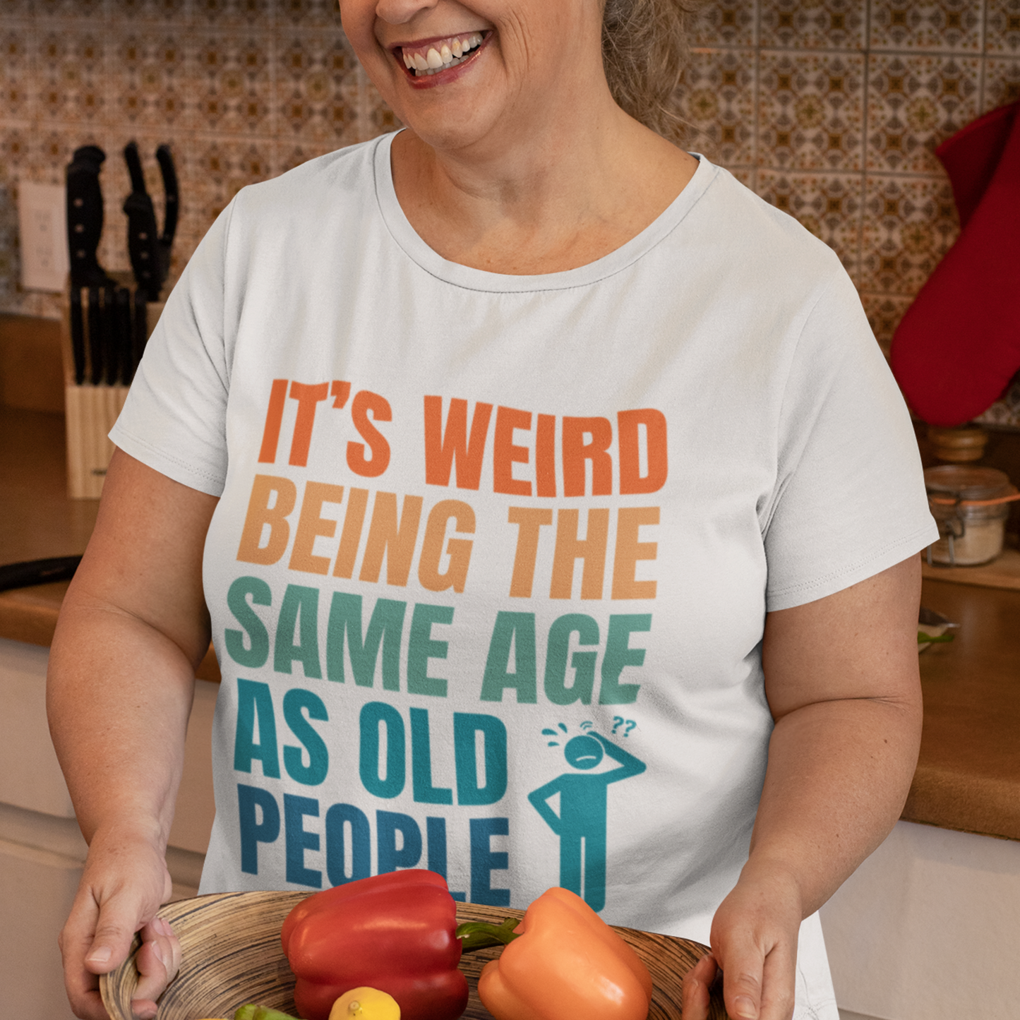 White tee featuring bold, multi-color lettering and with a pictogram of a person scratching their head in confusion