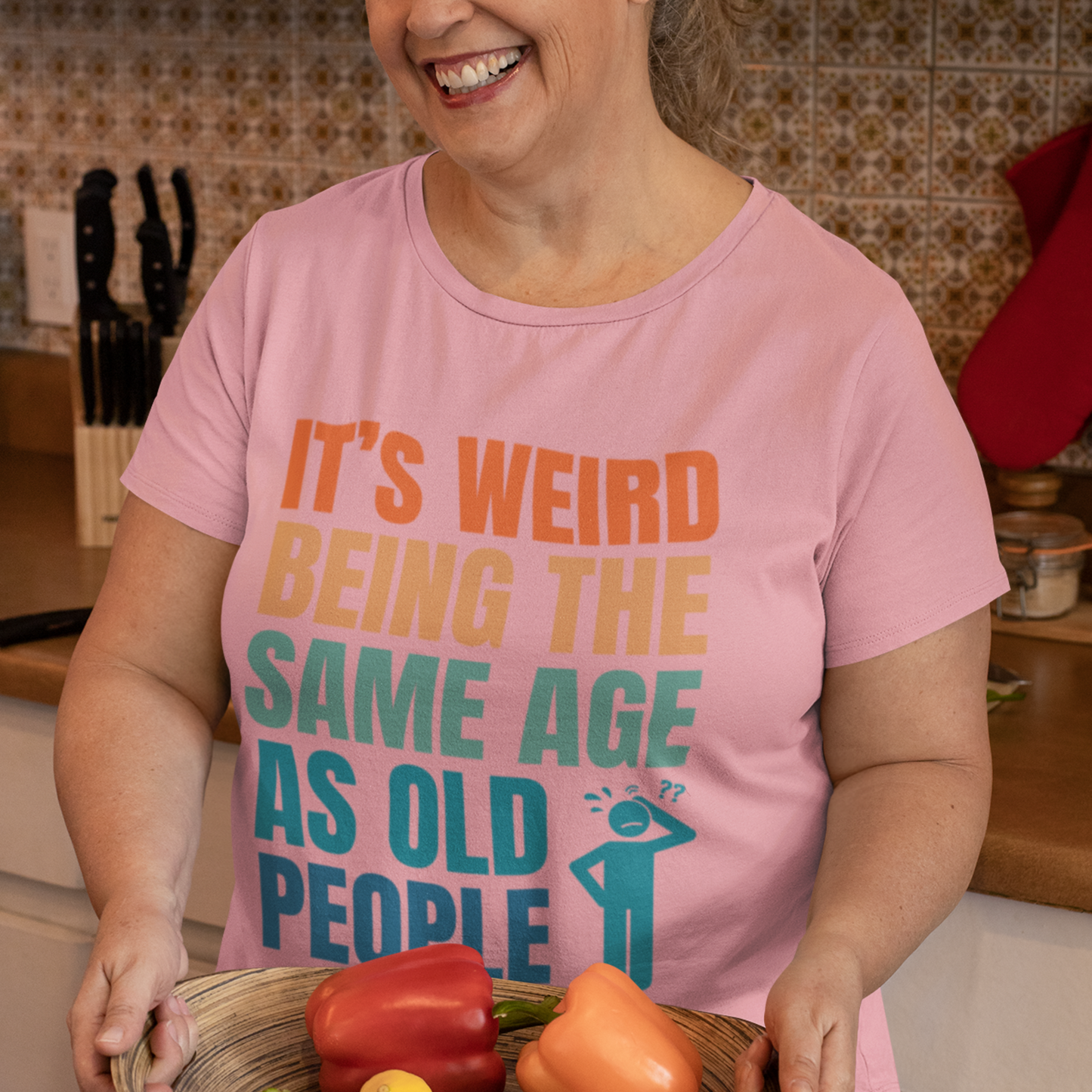 Pink tee featuring bold, multi-color lettering and with a pictogram of a person scratching their head in confusion