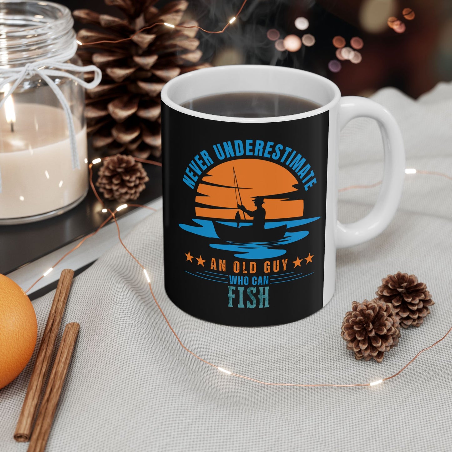 IRL black mug with fishing design and text on a table with decorative items