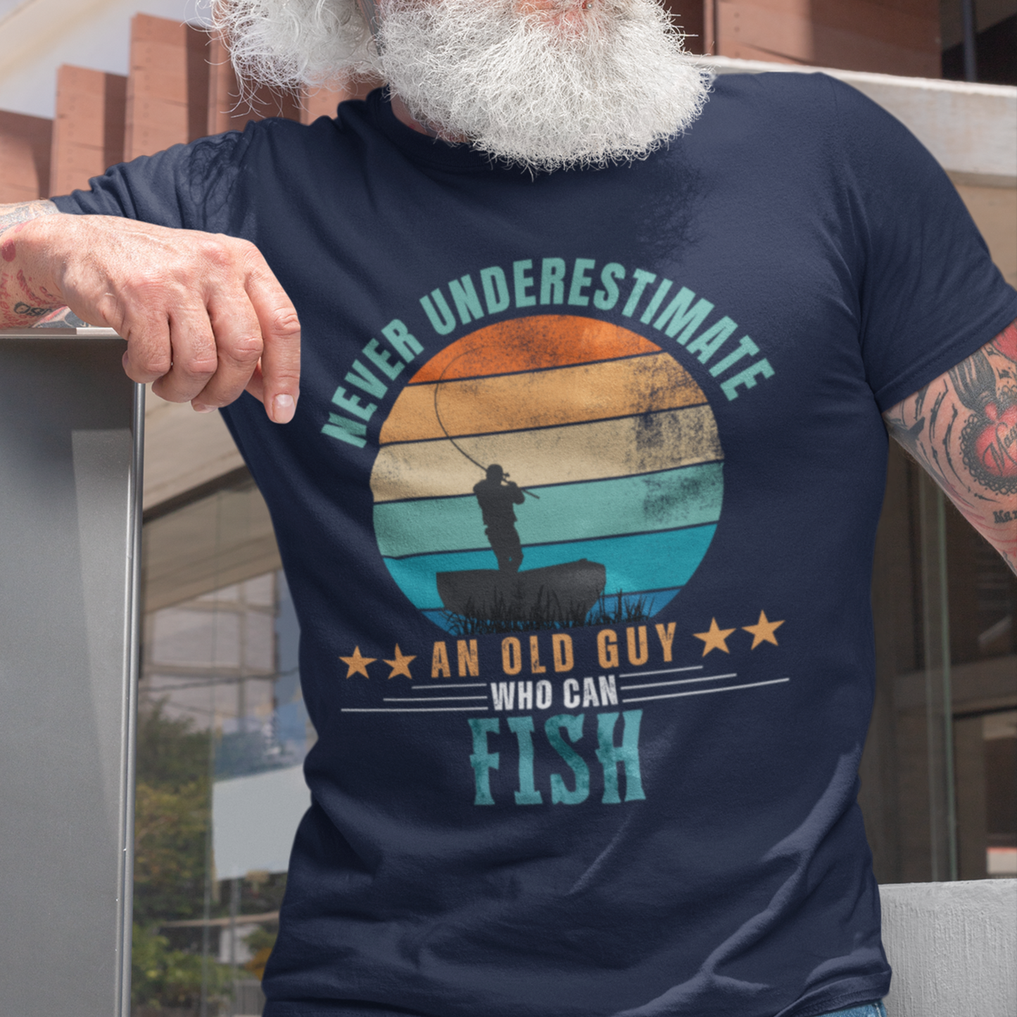 Navy blue tee featuring silhouette of a fisherman in his boat cast against a stylish distressed striped sunset