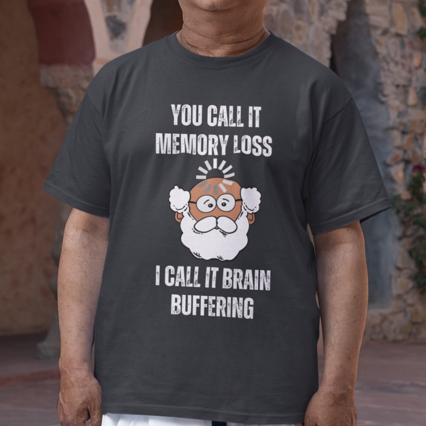Black t-shirt featuring the phrase 'Brain Buffering' with a loading icon graphic and a bald, bearded medium-toned senior.