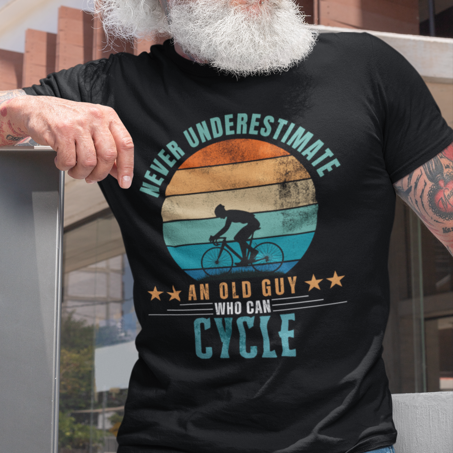 Black tee featuring silhouette of a guy on a bicycle against a distressed striped sunset