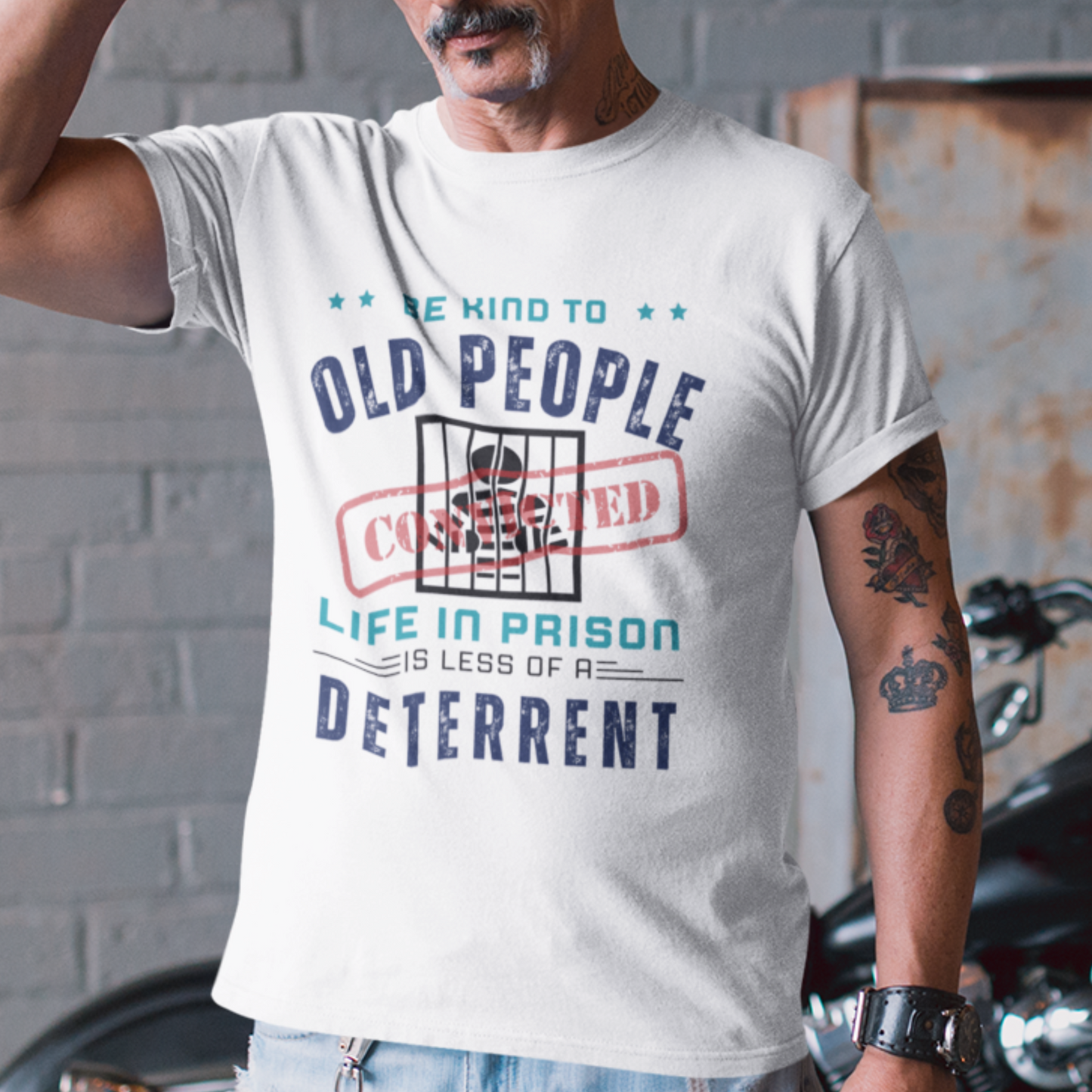 White t-shirt that reads Be Kind to Old People Life in Prison is Less of a Deterrent and features a prisoner behind bars pictogram.