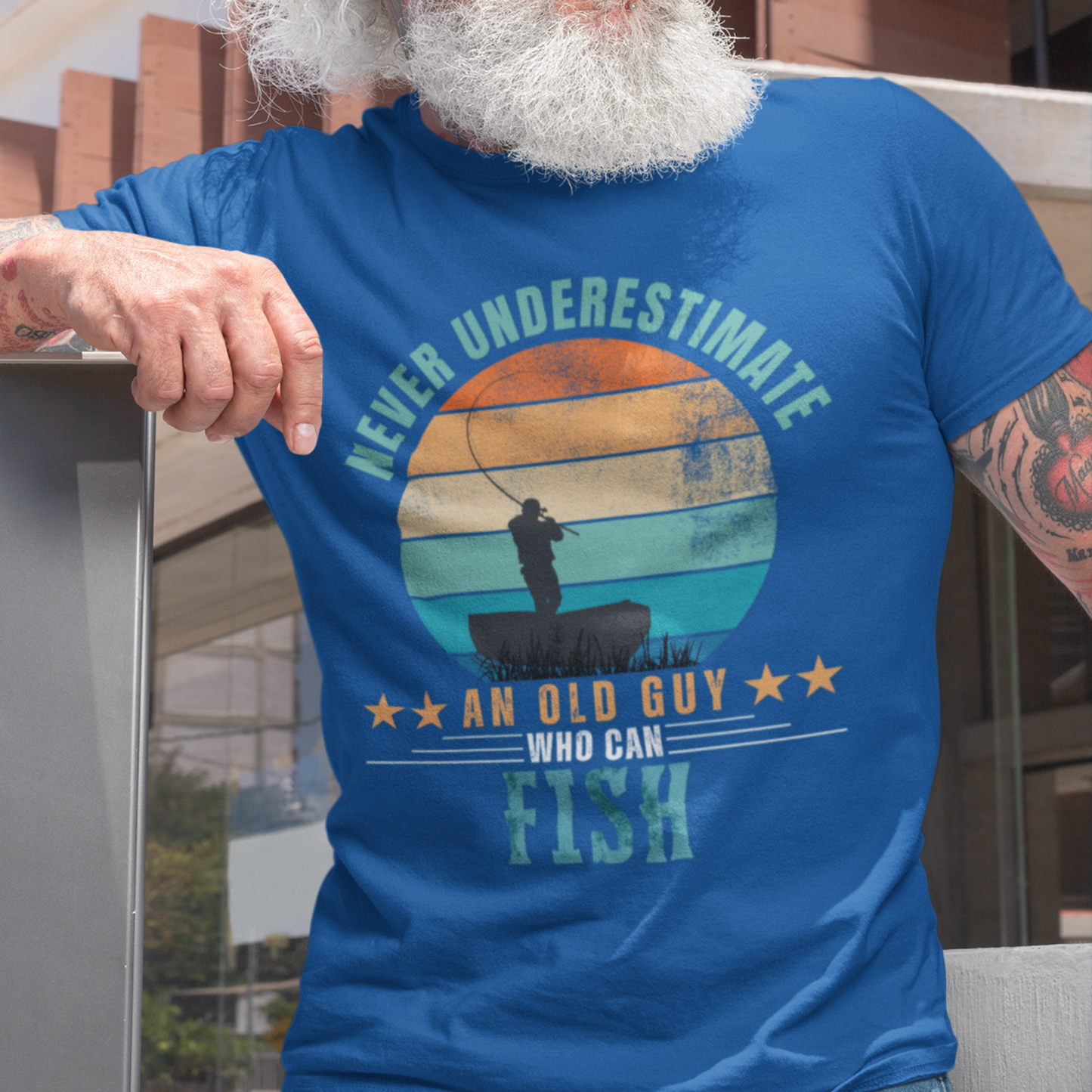 Royal blue tee featuring silhouette of a fisherman in his boat cast against a stylish distressed striped sunset