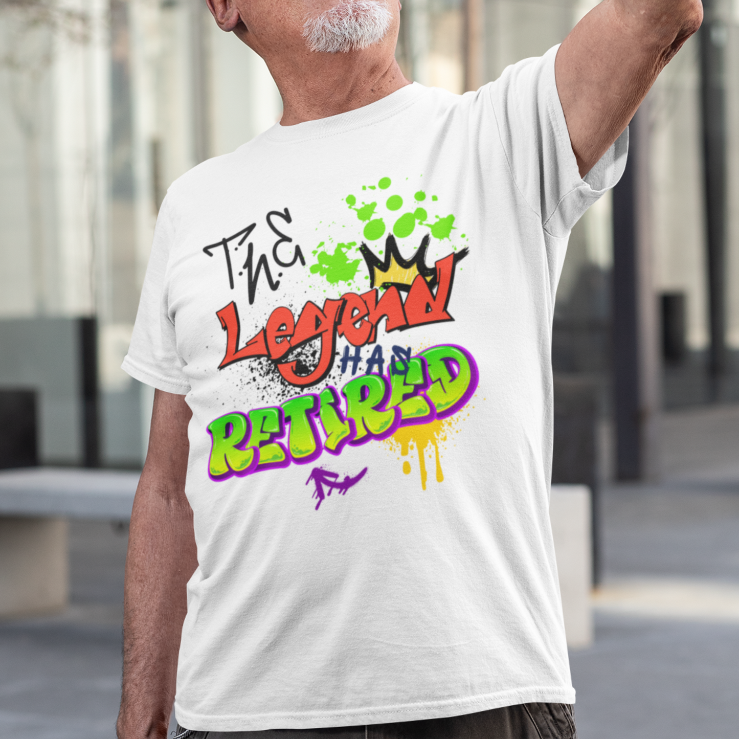 White t-shirt featuring bold graffiti style fonts states "The Legend Has Retired"