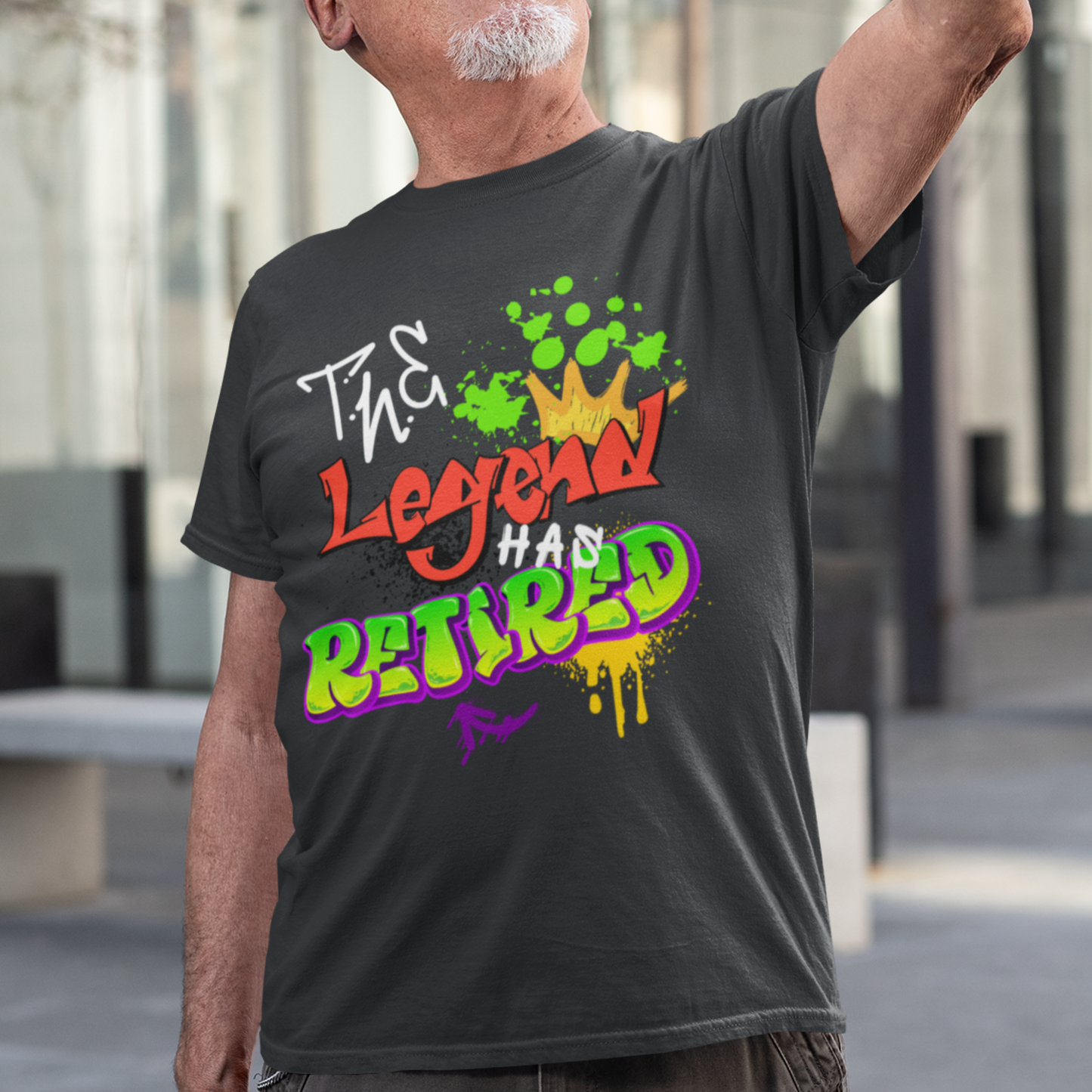 Black t-shirt featuring bold graffiti style fonts states "The Legend Has Retired"