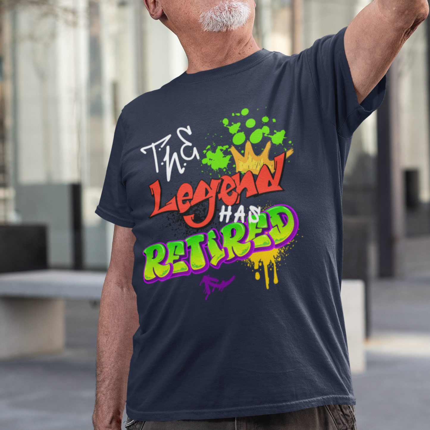 Navy blue t-shirt featuring bold graffiti style fonts states "The Legend Has Retired"