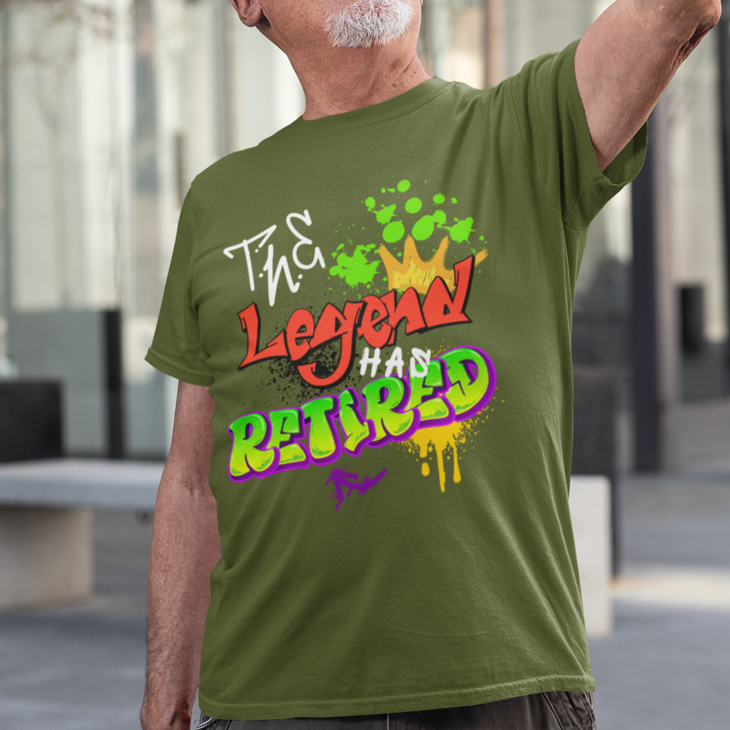 Military green t-shirt featuring bold graffiti style fonts states "The Legend Has Retired"