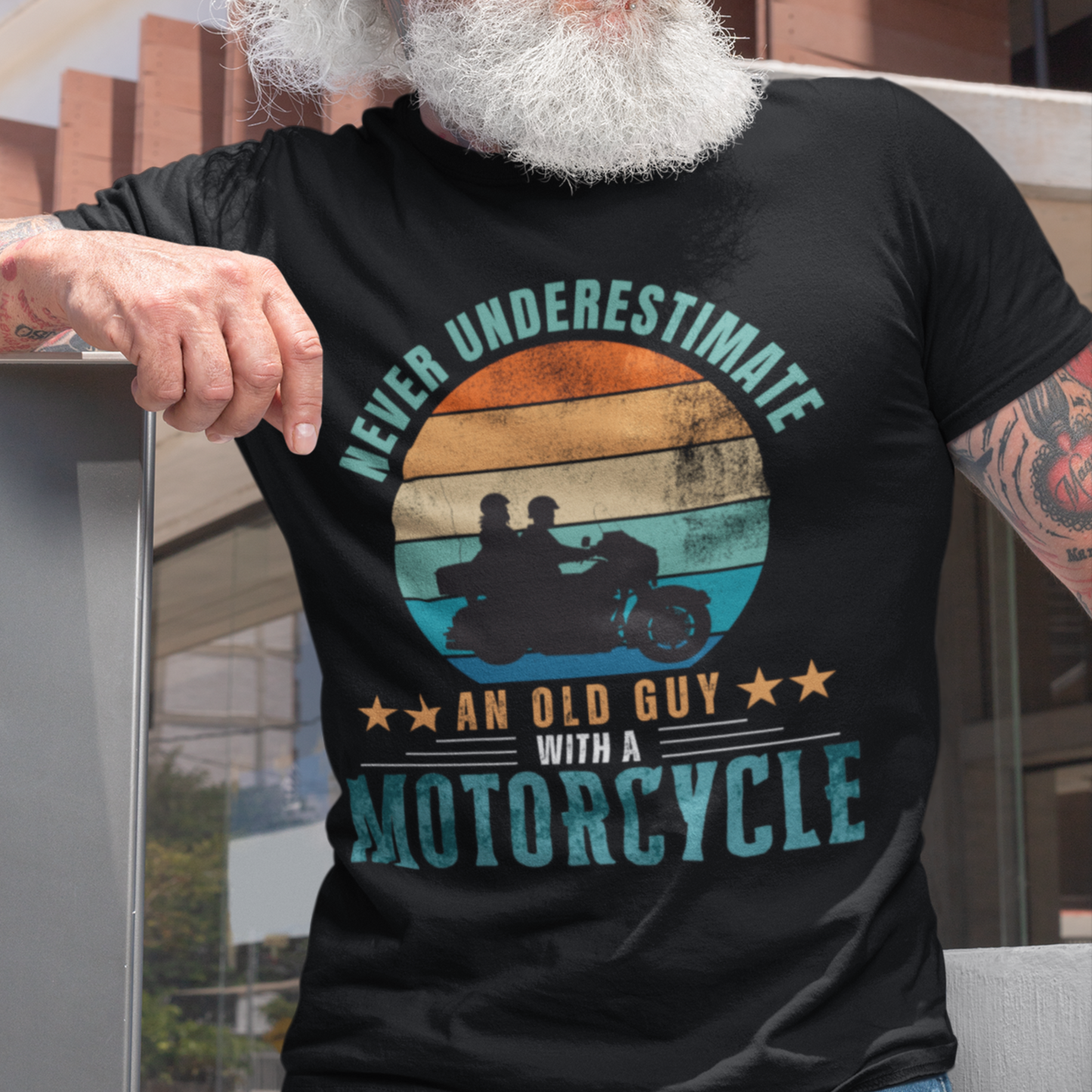 Black tee featuring silhouette of a guy on a cruiser with his lady against a distressed striped sunset