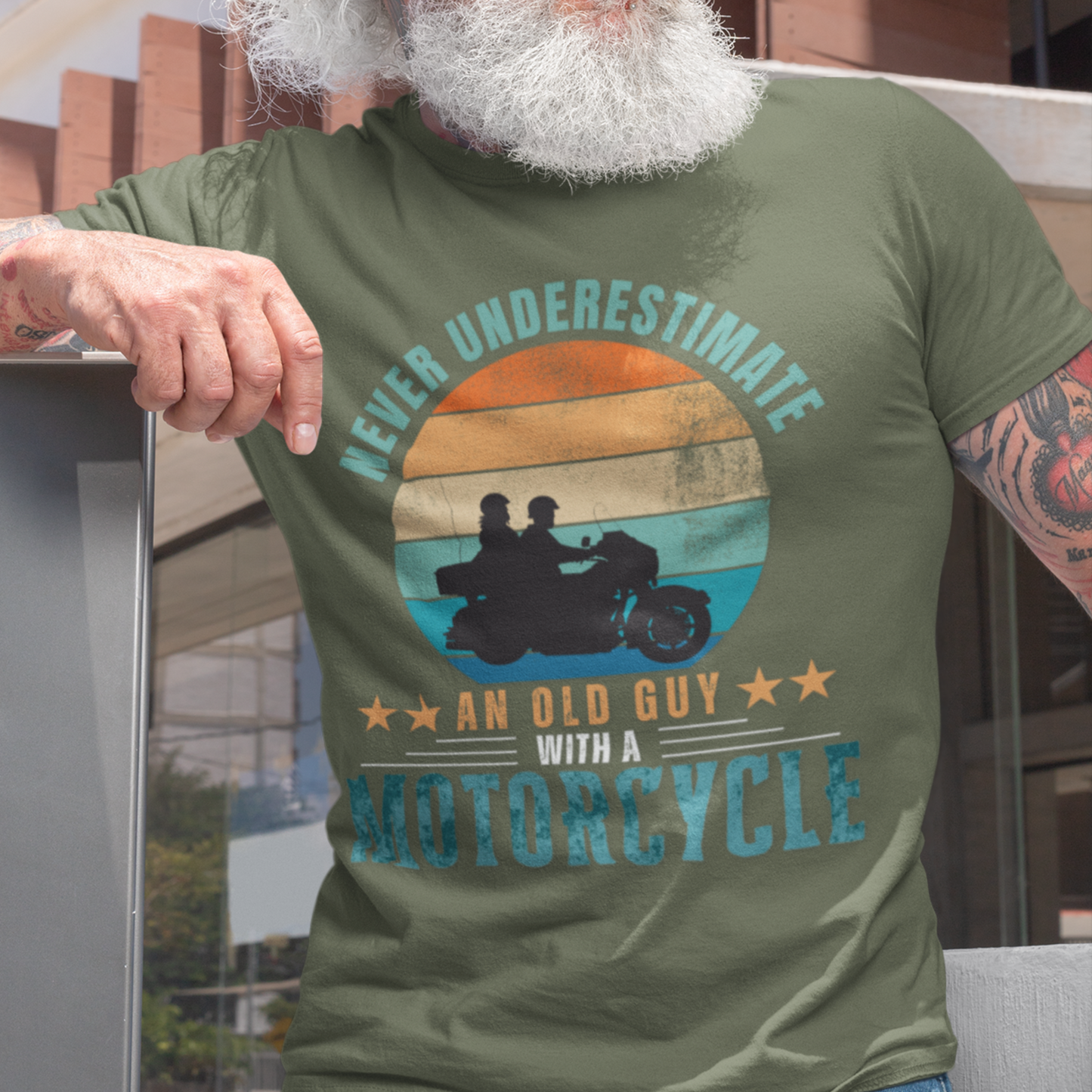 Military green tee featuring silhouette of a guy on a cruiser with his lady against a distressed striped sunset