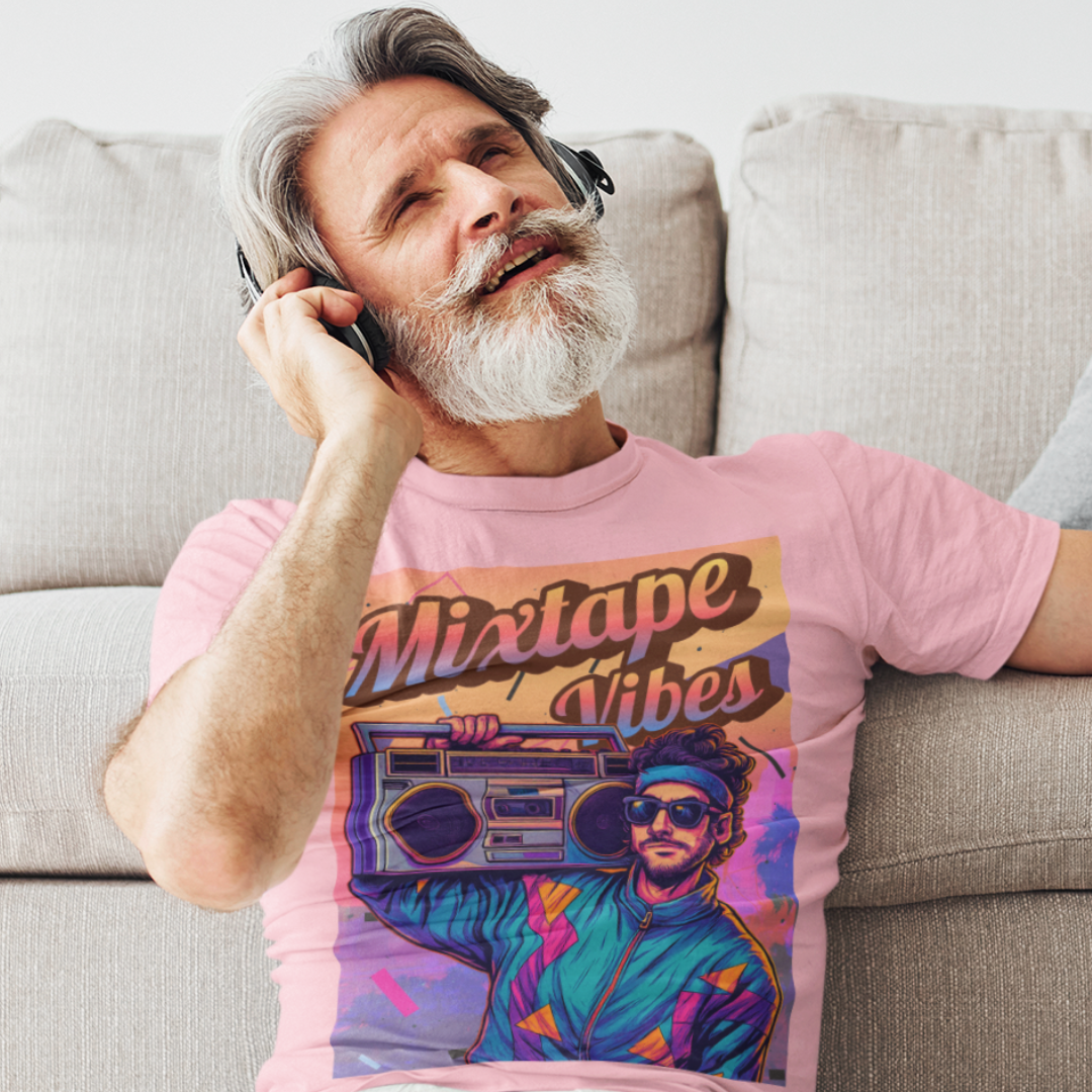 Light pink tee featuring a young man girl from the 1980s listening to his boom box with a pastel sunset in the background