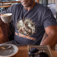 Navy blue tee featuring a senior man at his kitchen table enjoying a hot cup of coffee.
