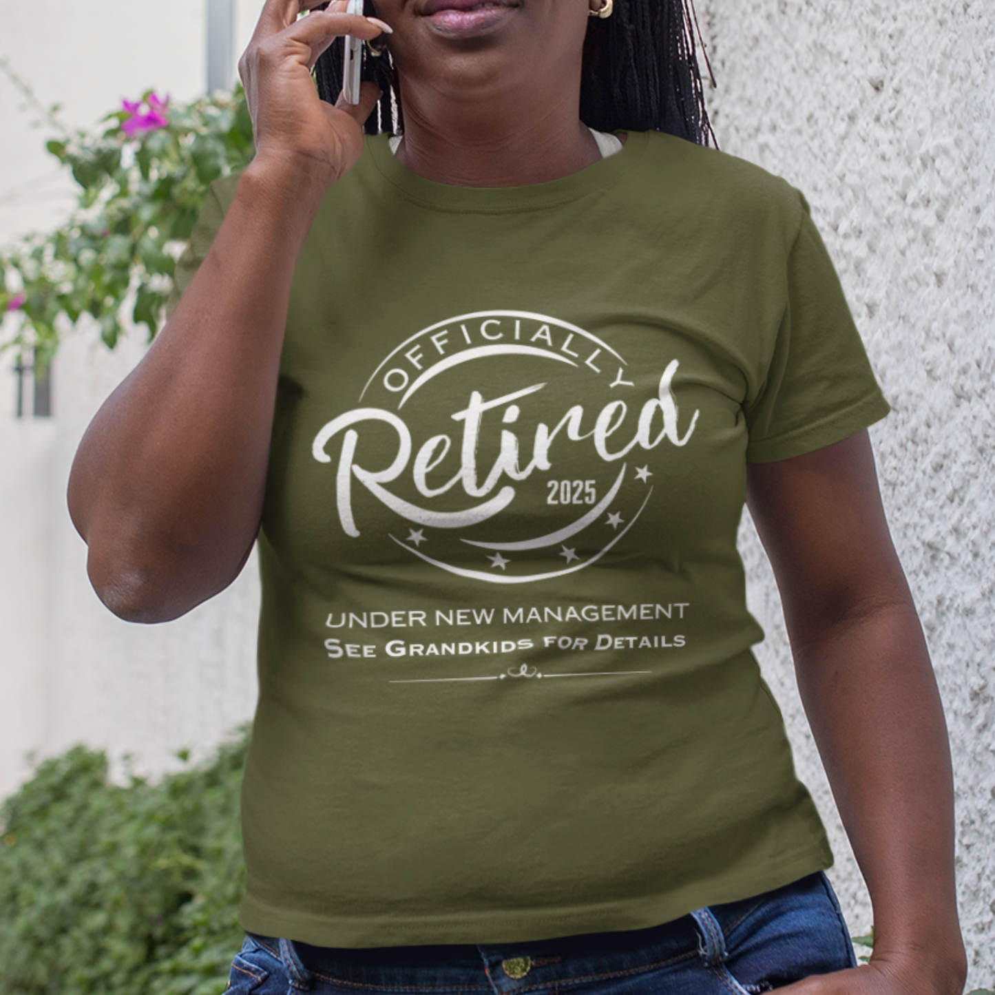 Military green tee featuring a replica of an official stamp embossing that reads "Officially Retired 2025 See Grandkids" on a woman.