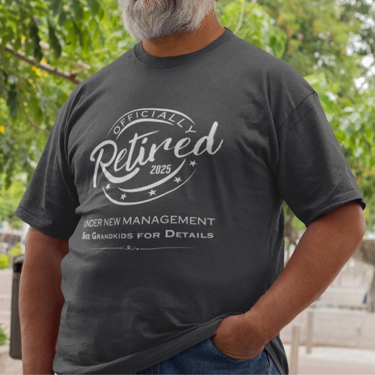 Black tee featuring a replica of an official stamp embossing that reads "Officially Retired 2025 See Grandkids".