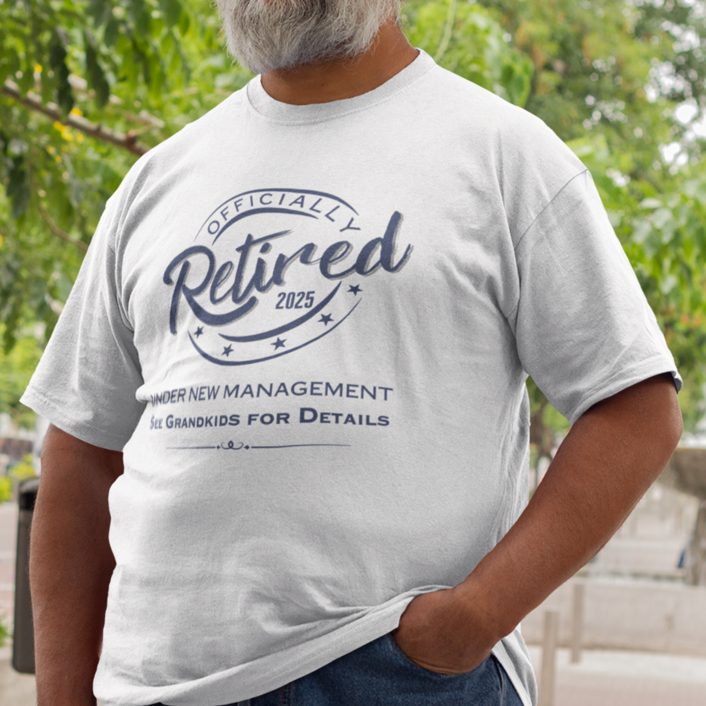 White tee featuring a replica of an official stamp embossing that reads "Officially Retired 2025 See Grandkids".