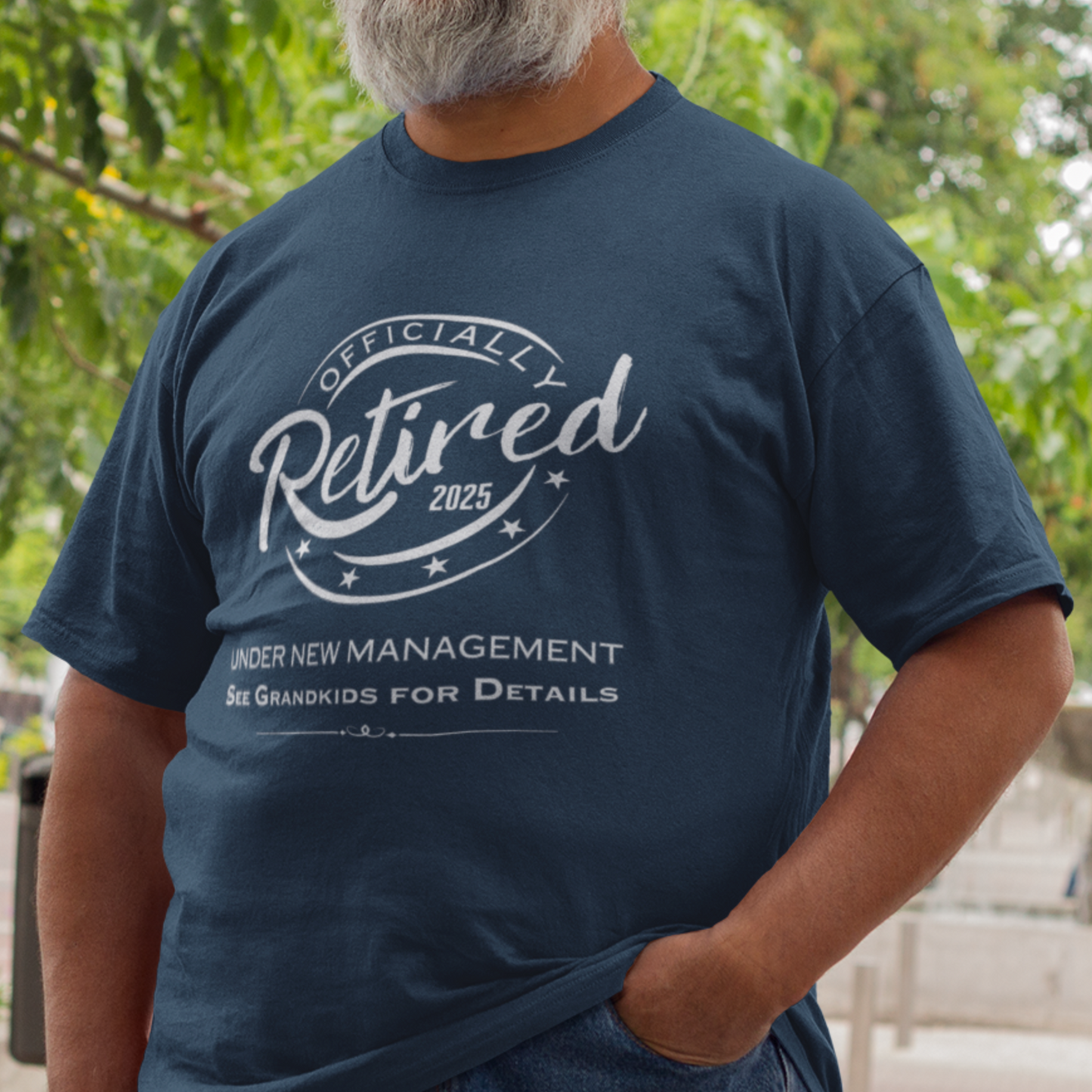 Navy blue tee featuring a replica of an official stamp embossing that reads "Officially Retired 2025 See Grandkids".