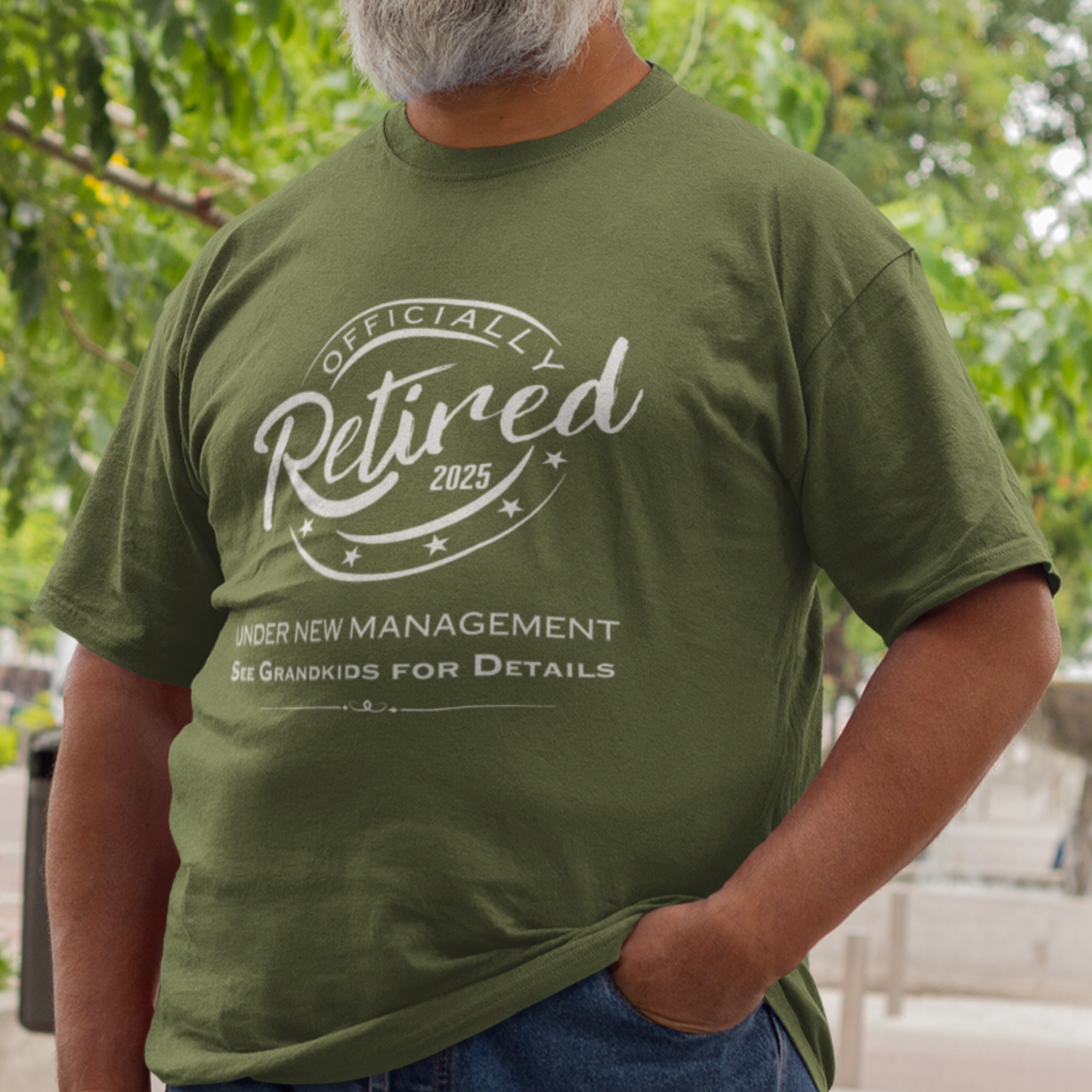 Military green tee featuring a replica of an official stamp embossing that reads "Officially Retired 2025 See Grandkids".