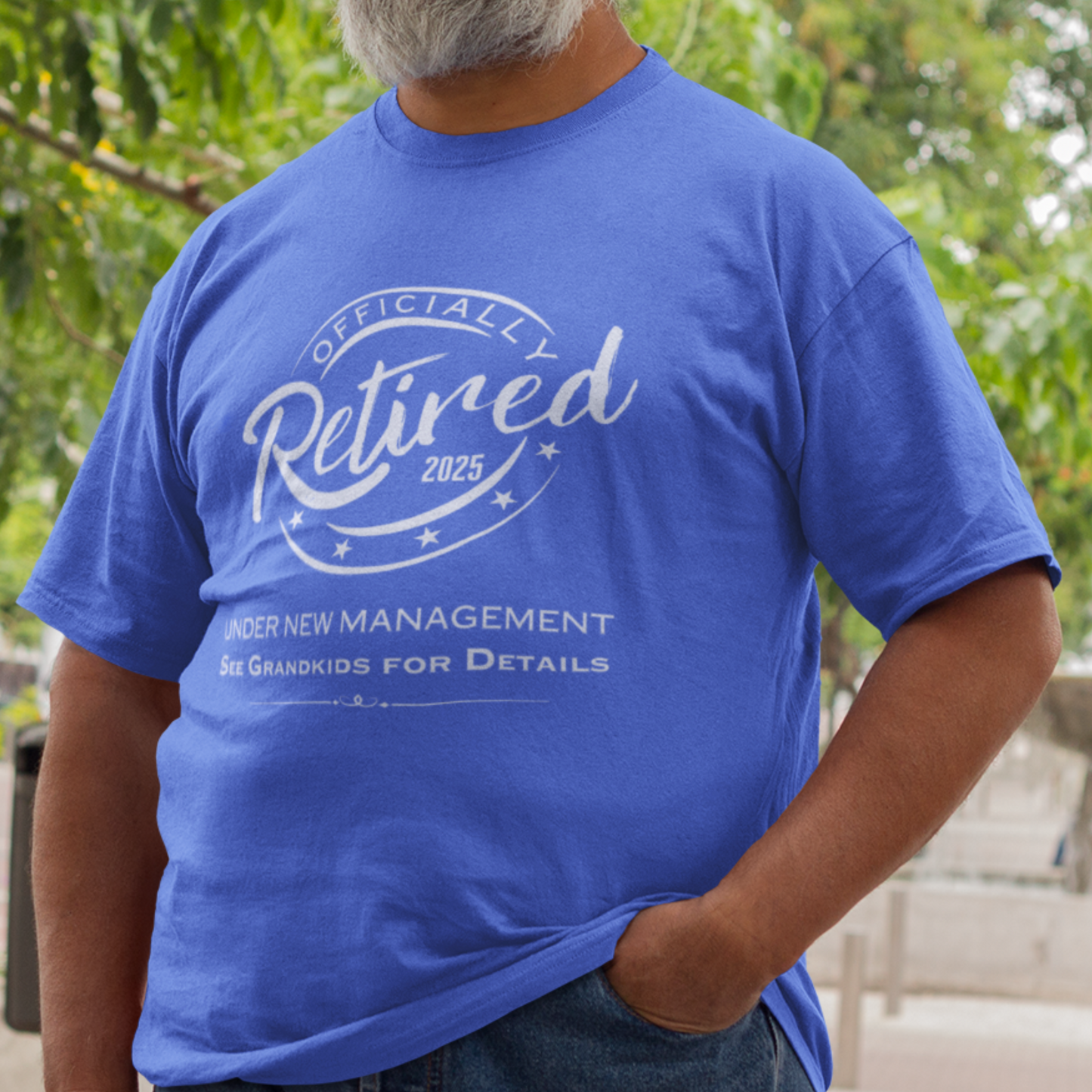 Royal blue tee featuring a replica of an official stamp embossing that reads "Officially Retired 2025 See Grandkids".