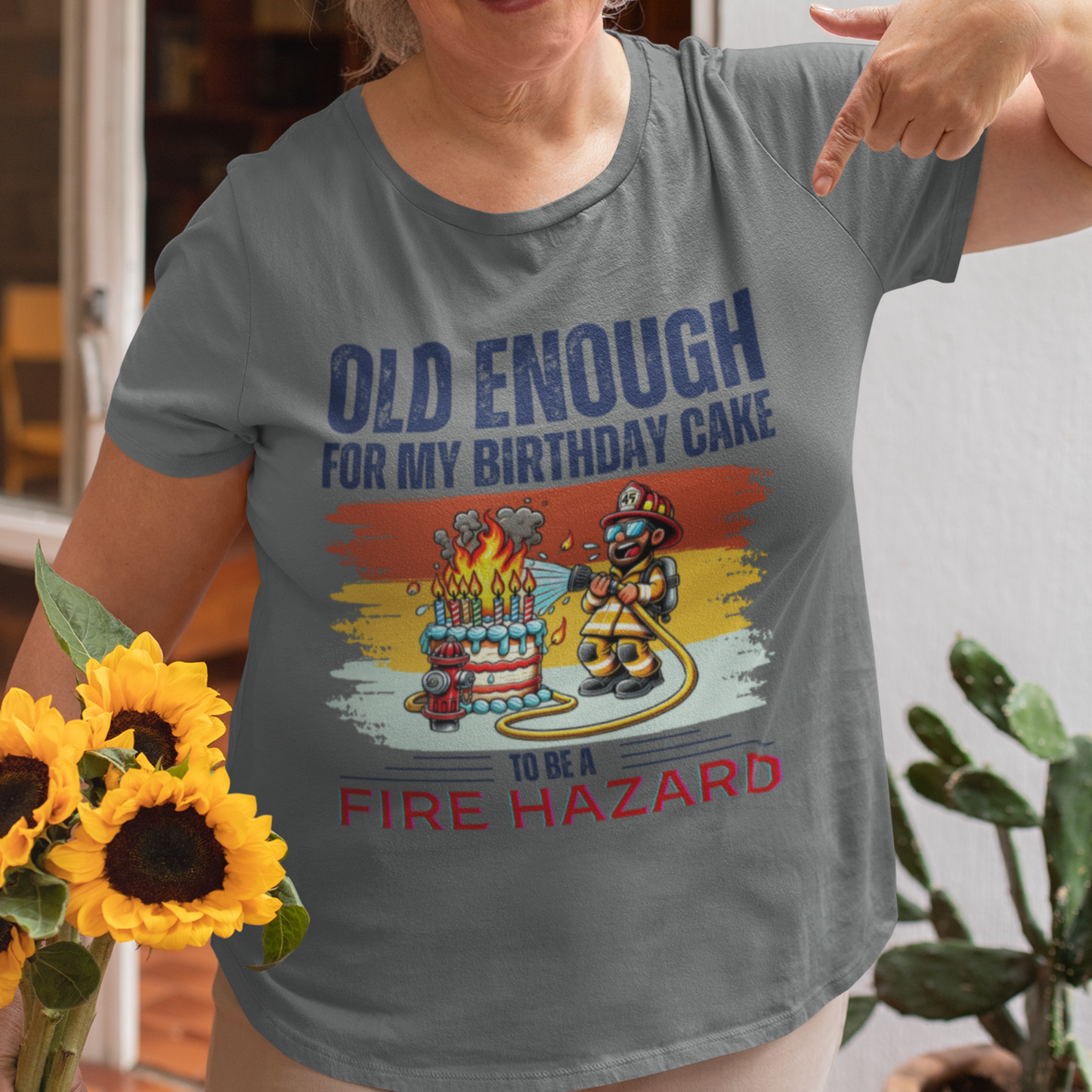 Heather gray tee featuring a cartoon fireman putting out the flames from the candles on a birthday cake.