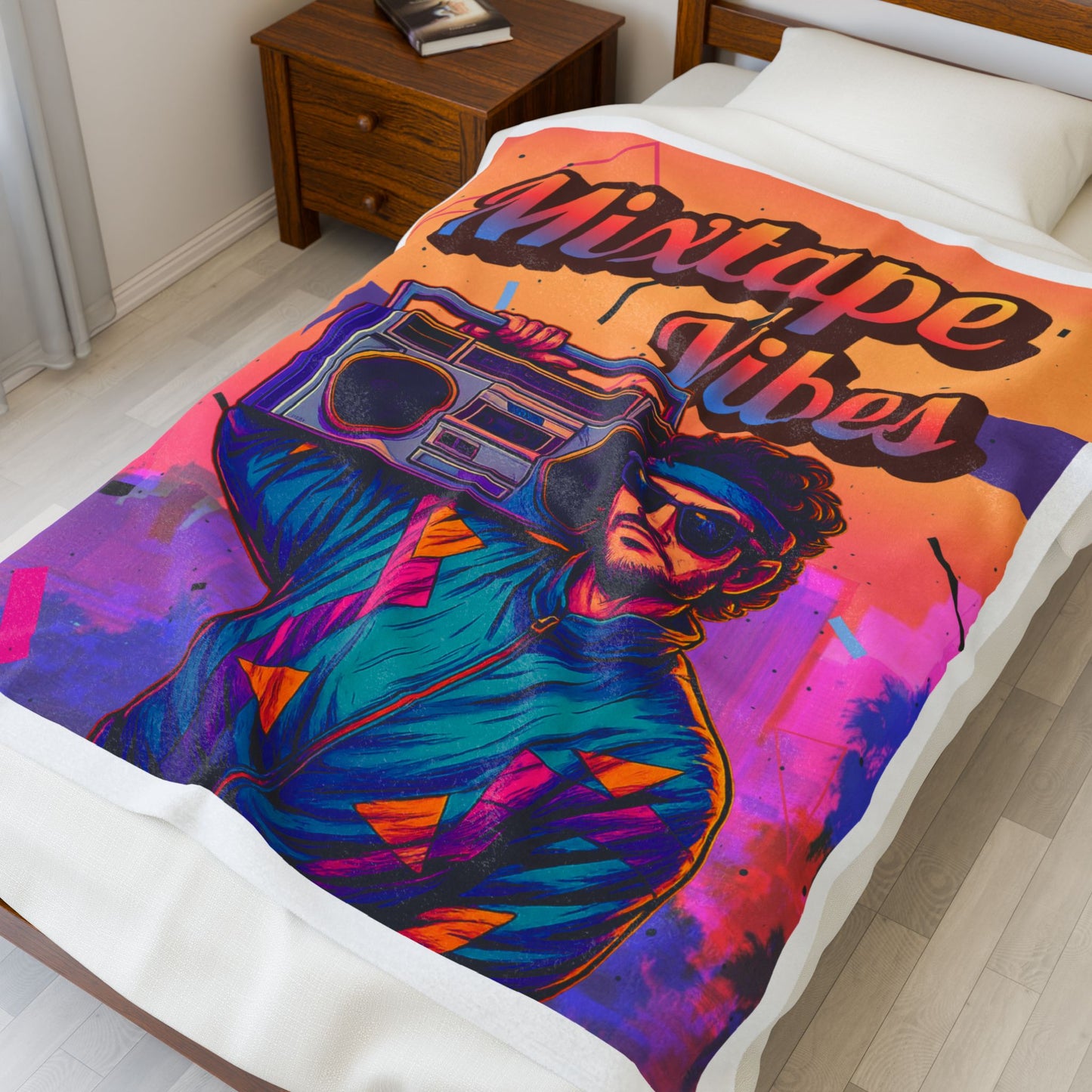 50X60 Colorful plush blanket with a design of a person holding a boombox and 'Mixtape Vibes' text on a bed.