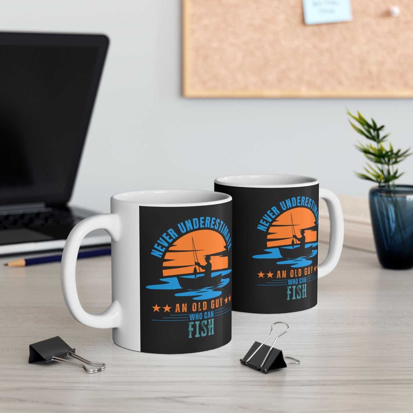 Two mugs showing both left and right views with fishing-themed designs on a desk.