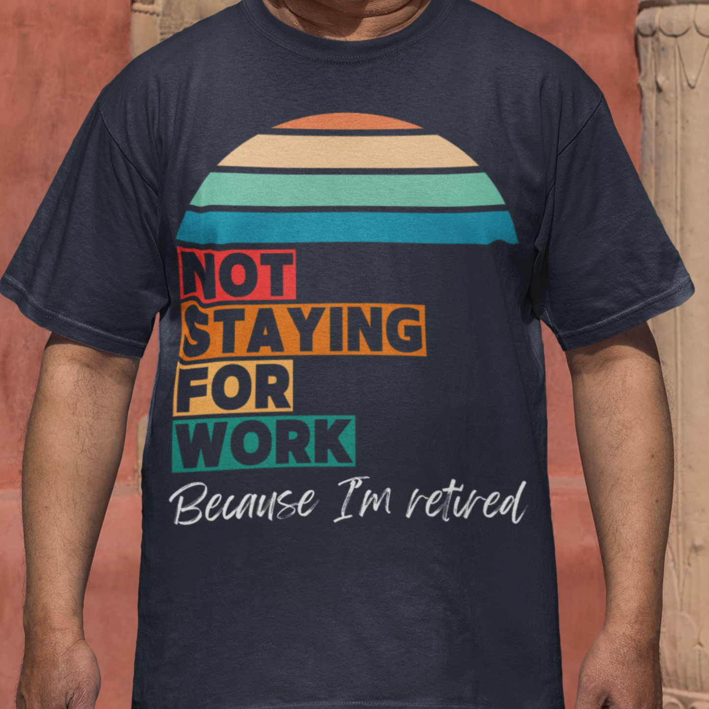 Navy blue tee in multi-color block lettering and rainbow sun reads Not Staying for Work I'm Retired
