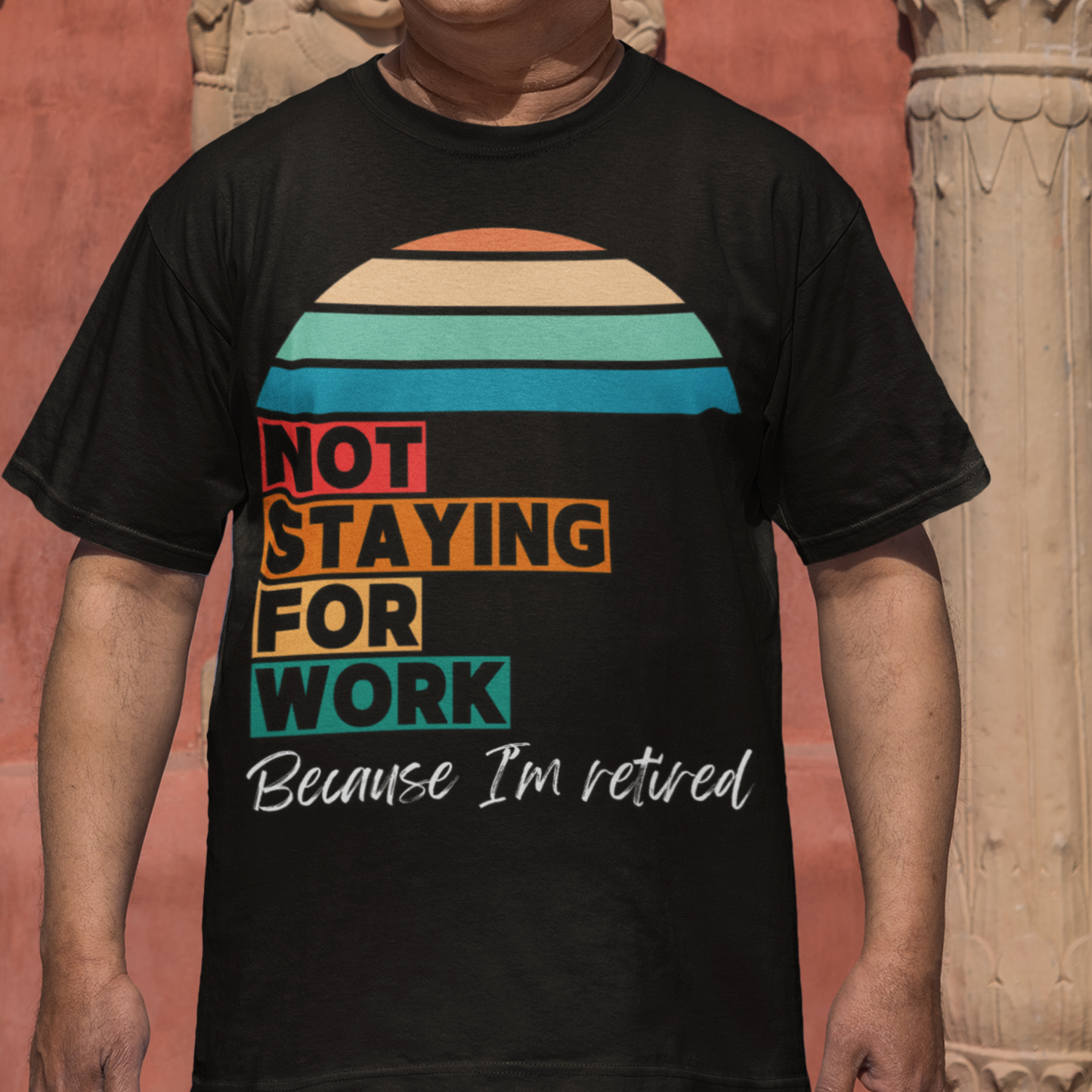 Black tee in multi-color block lettering and rainbow sun reads Not Staying for Work I'm Retired