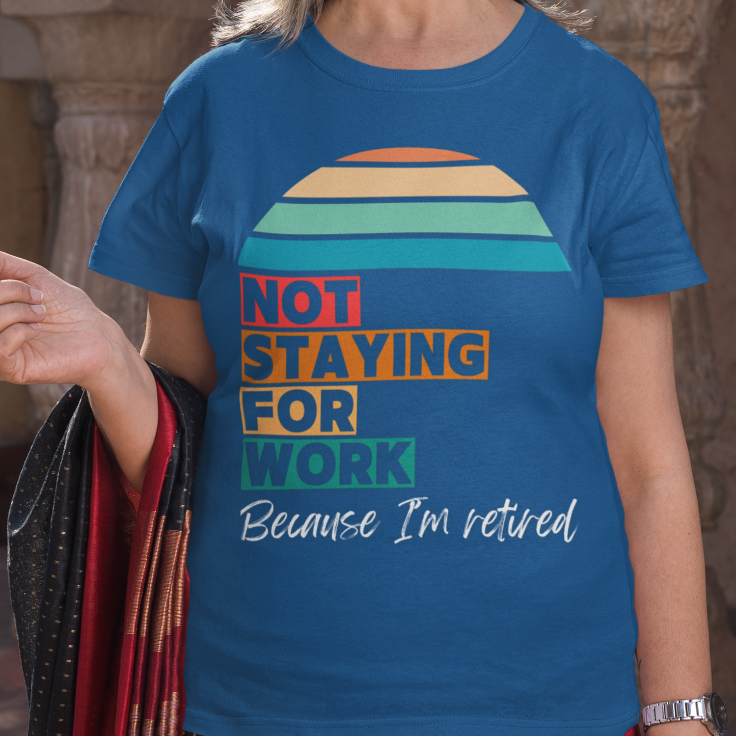 royal blue tee in multi-color block lettering and rainbow sun reads Not Staying for Work I'm Retired