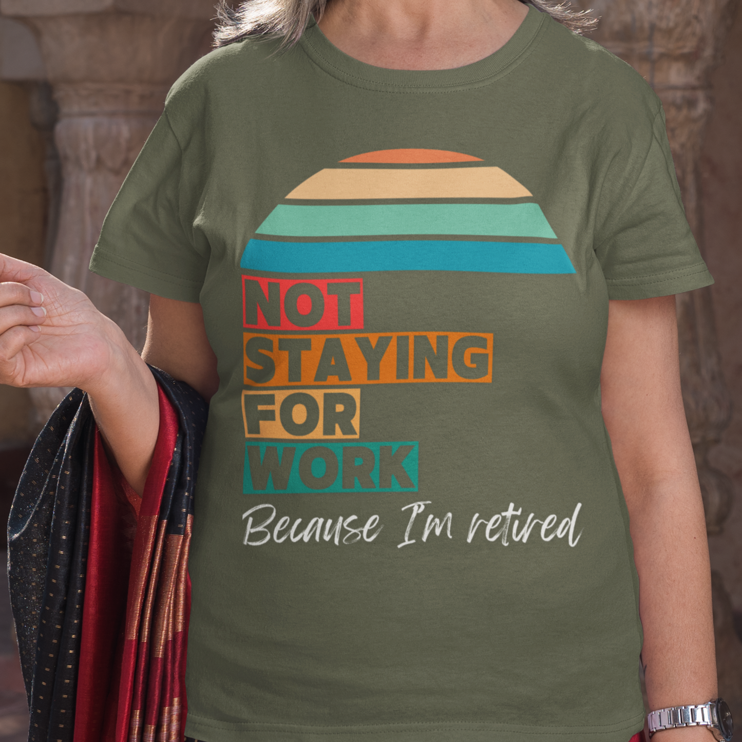 Military green tee in multi-color block lettering and rainbow sun reads Not Staying for Work I'm Retired