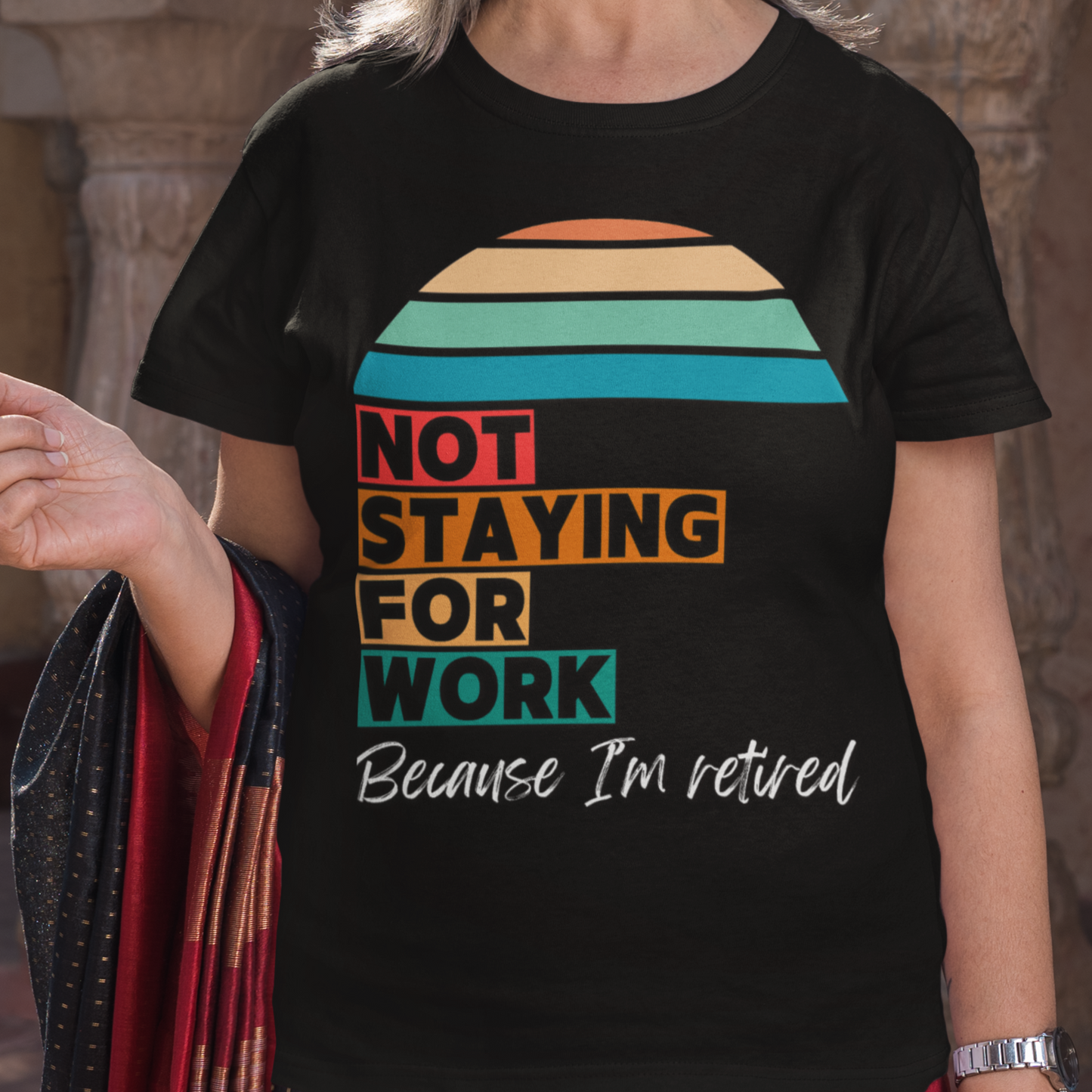 Black tee in multi-color block lettering and rainbow sun reads Not Staying for Work I'm Retired
