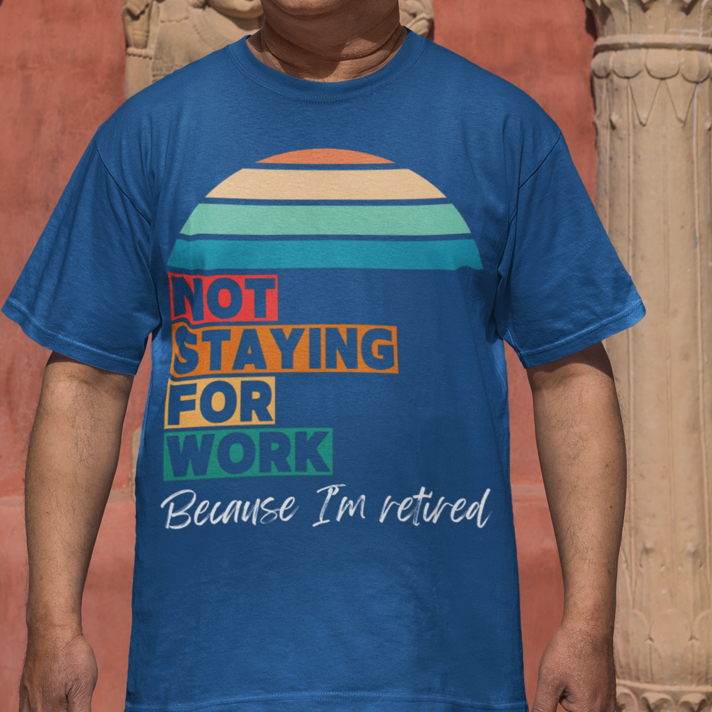 Royal blue tee in multi-color block lettering and rainbow sun reads Not Staying for Work I'm Retired