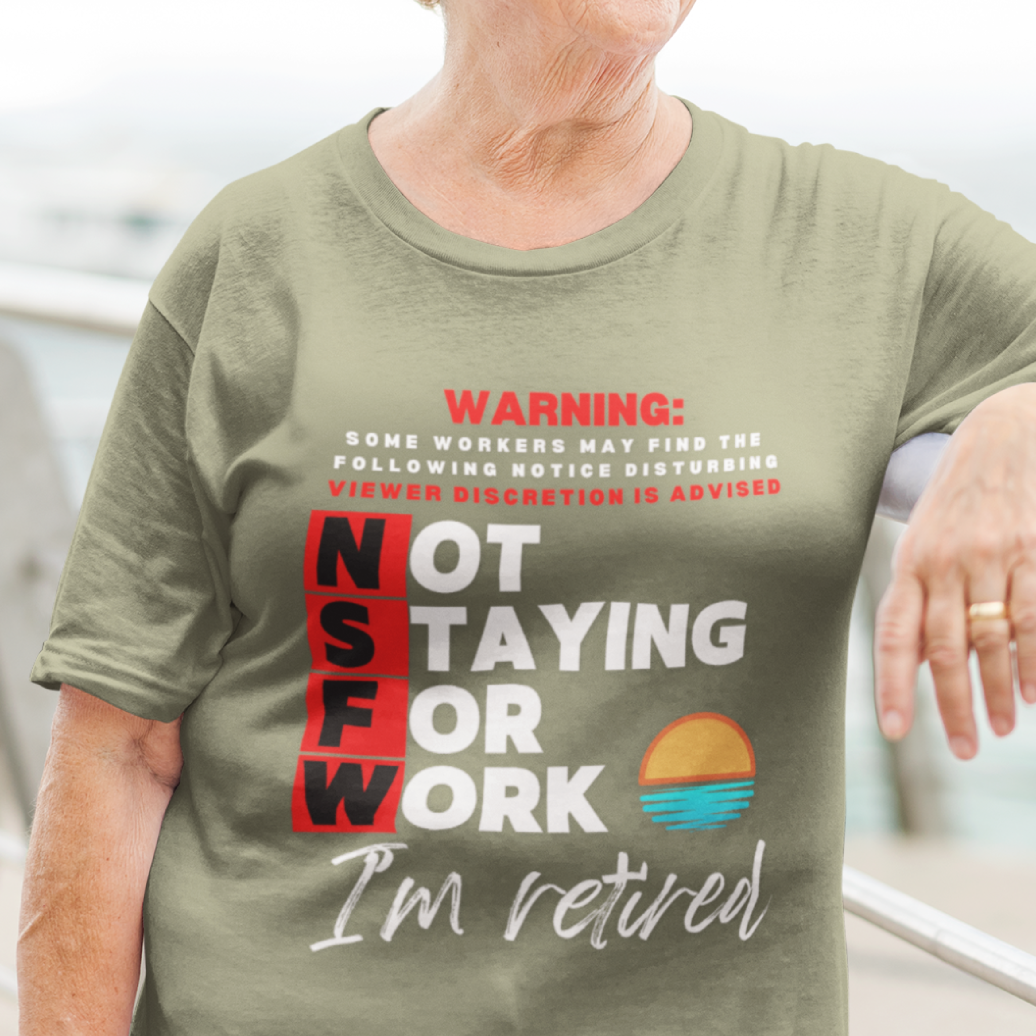 Military green tee with movie-style design of the NSFW warning and a sunset motif announcing retirement