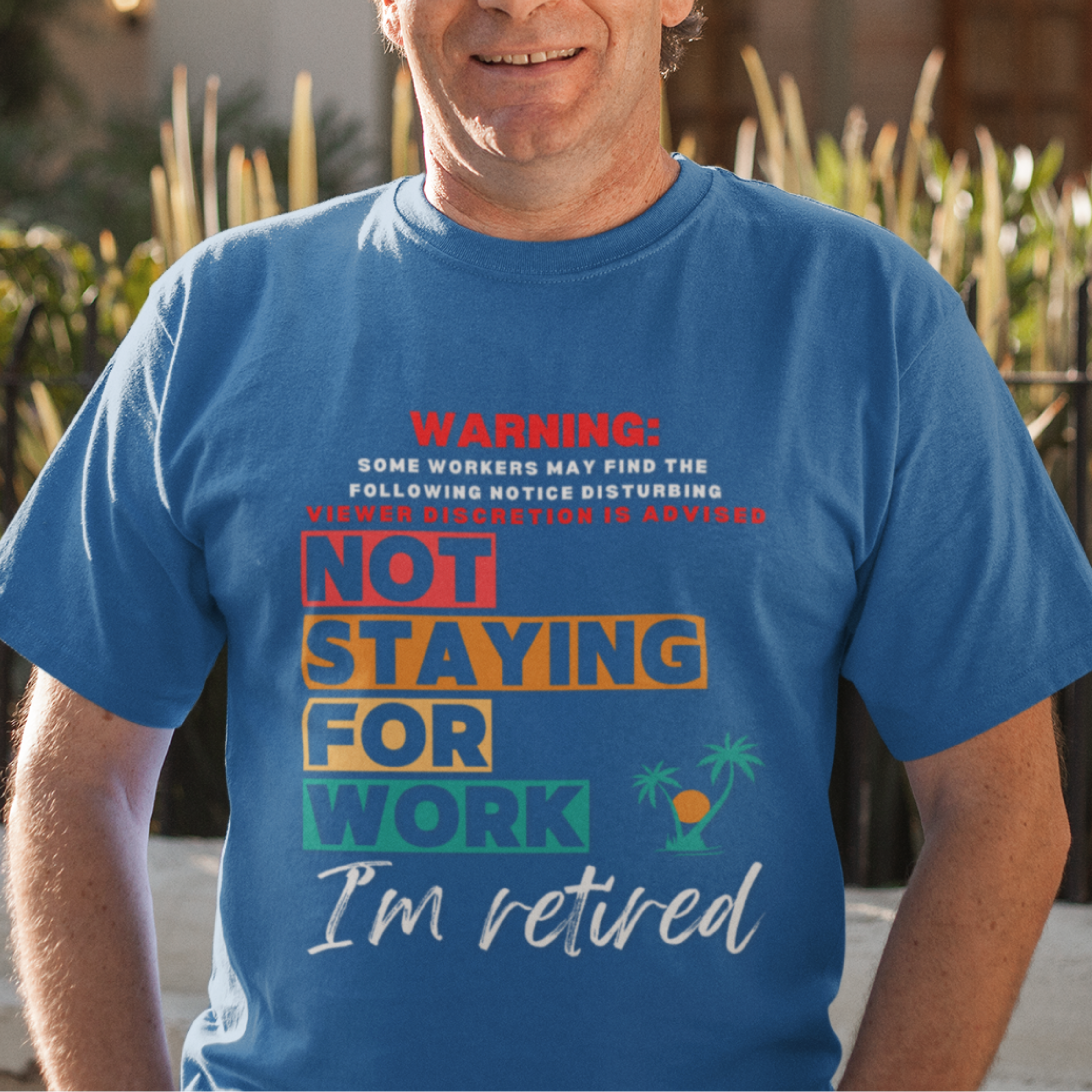 Royal blue tee featuring a NSFW warning in multi-color block lettering reads Not Staying for Work I'm Retired 