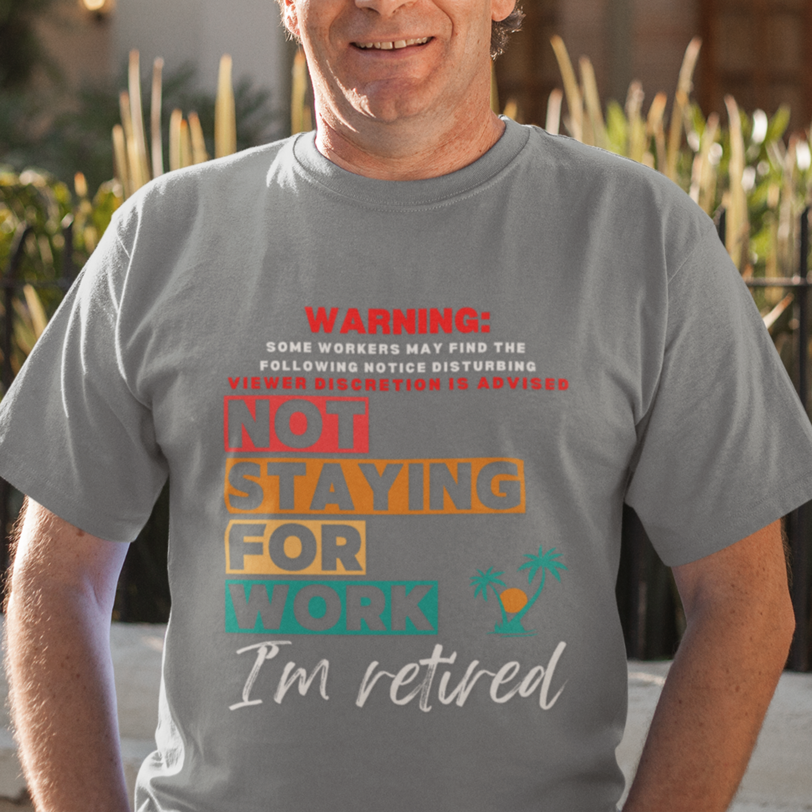 Gray tee featuring a NSFW warning in multi-color block lettering reads Not Staying for Work I'm Retired