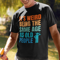 Black tee featuring bold, multi-color lettering and with a pictogram of a person scratching their head in confusion
