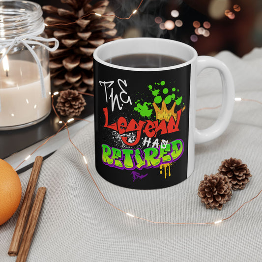 Mug with colorful text design on a table with decorative items