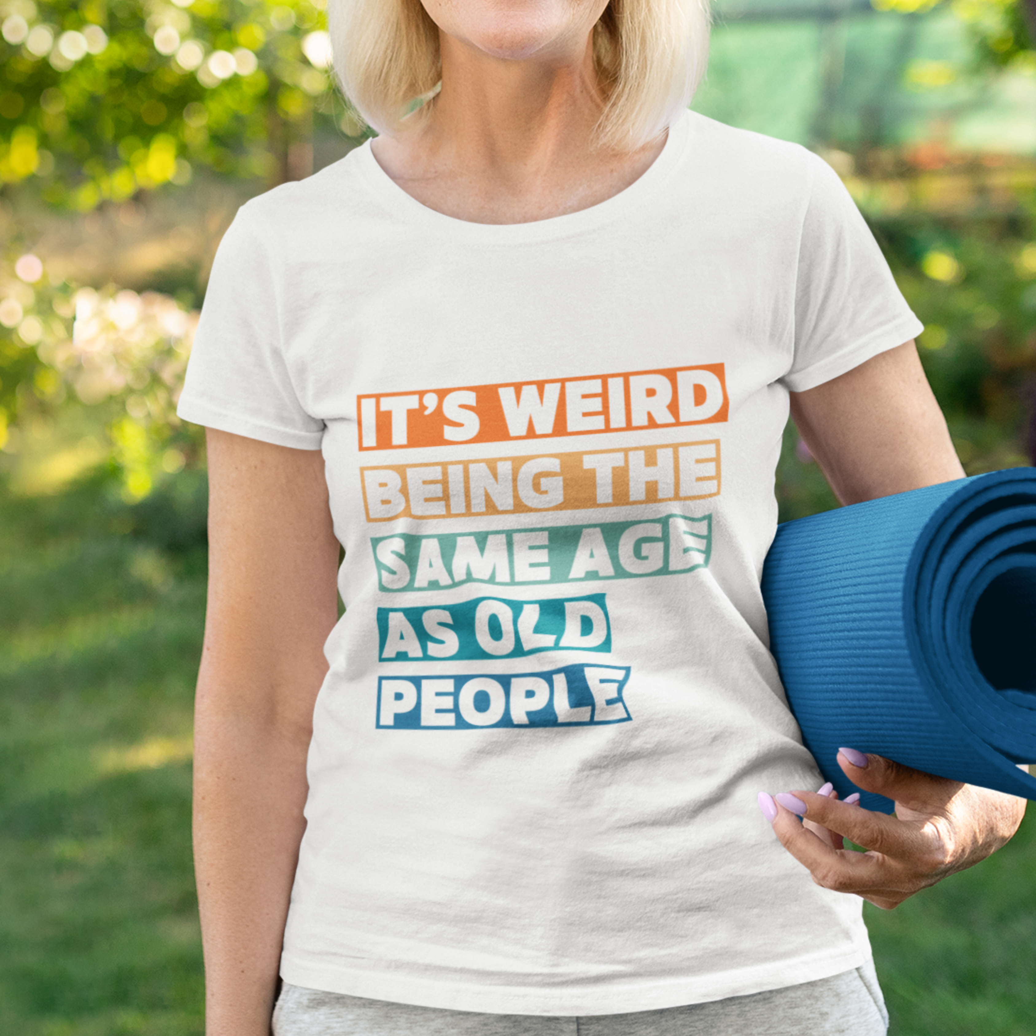 White tee featuring bold, multi-color block lettering reads It’s Weird Being the Same Age as Old People 