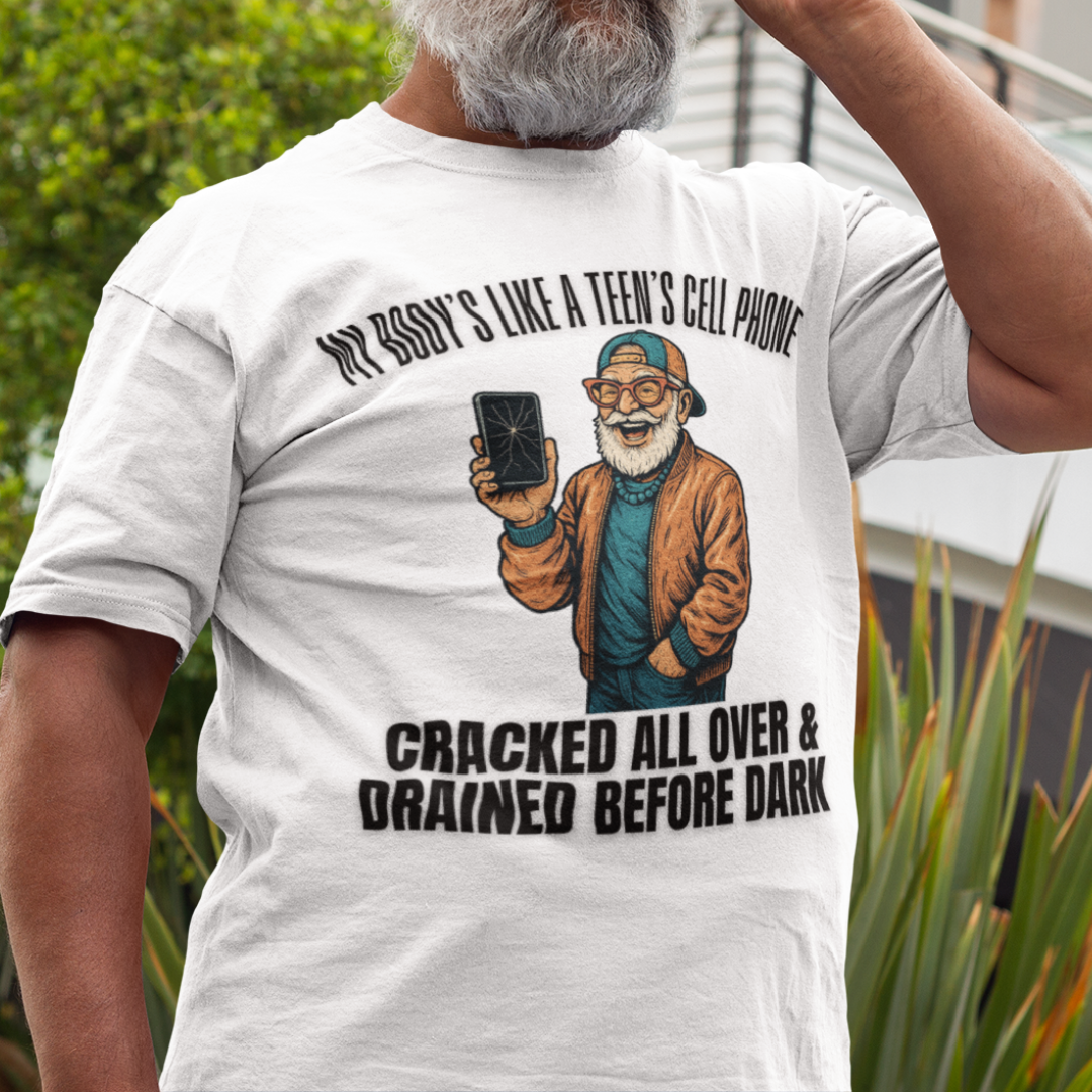 White t-shirt featuring a cartoon white-bearded man with a broken cell phone, laughing