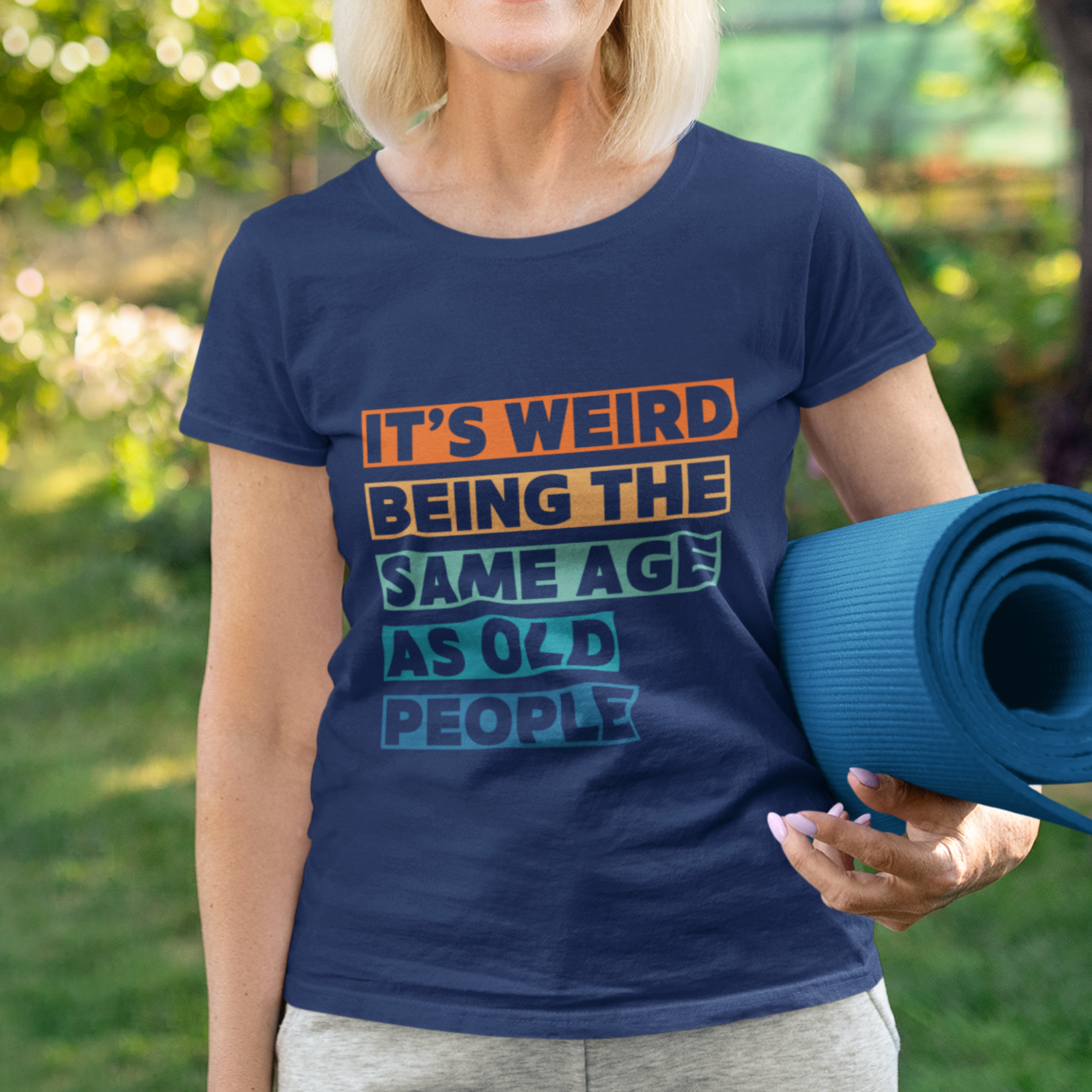 Navy blue tee featuring bold, multi-color block lettering reads It’s Weird Being the Same Age as Old People 