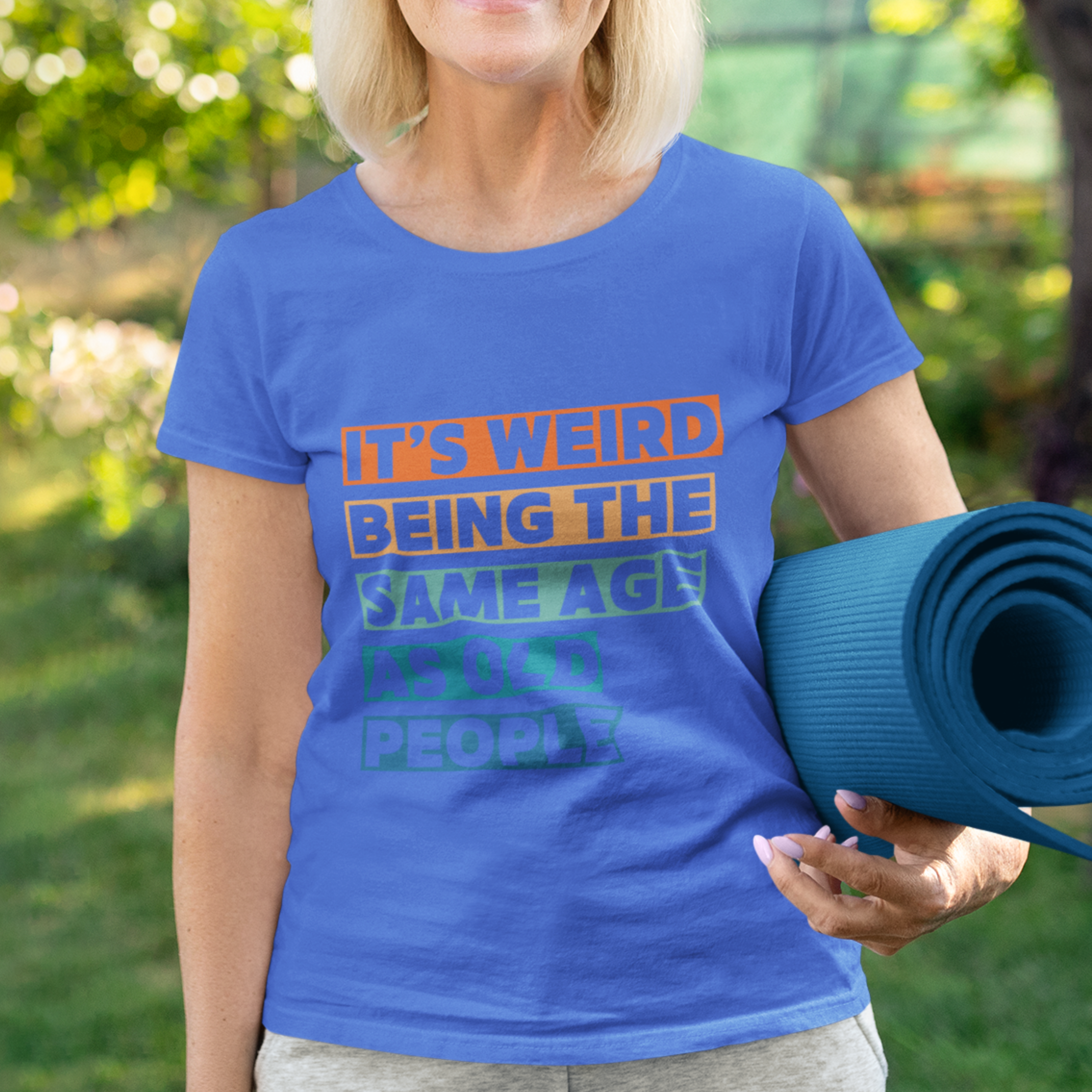 Royal blue tee featuring bold, multi-color block lettering reads It’s Weird Being the Same Age as Old People 