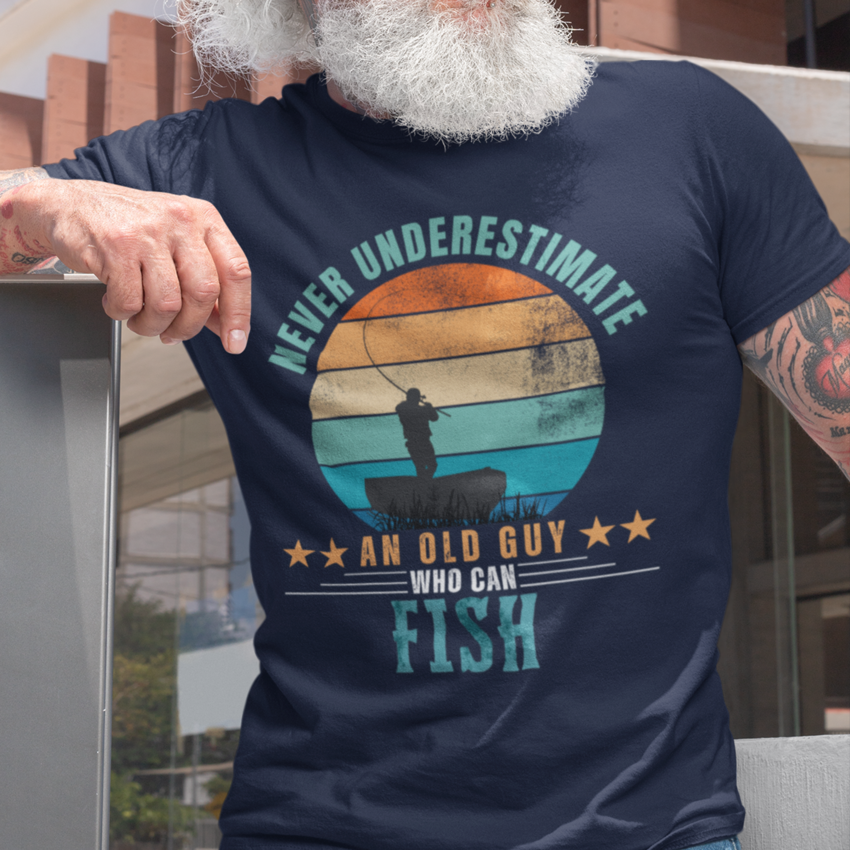 Navy blue tee featuring silhouette of a fisherman in his boat cast against a stylish distressed striped sunset 