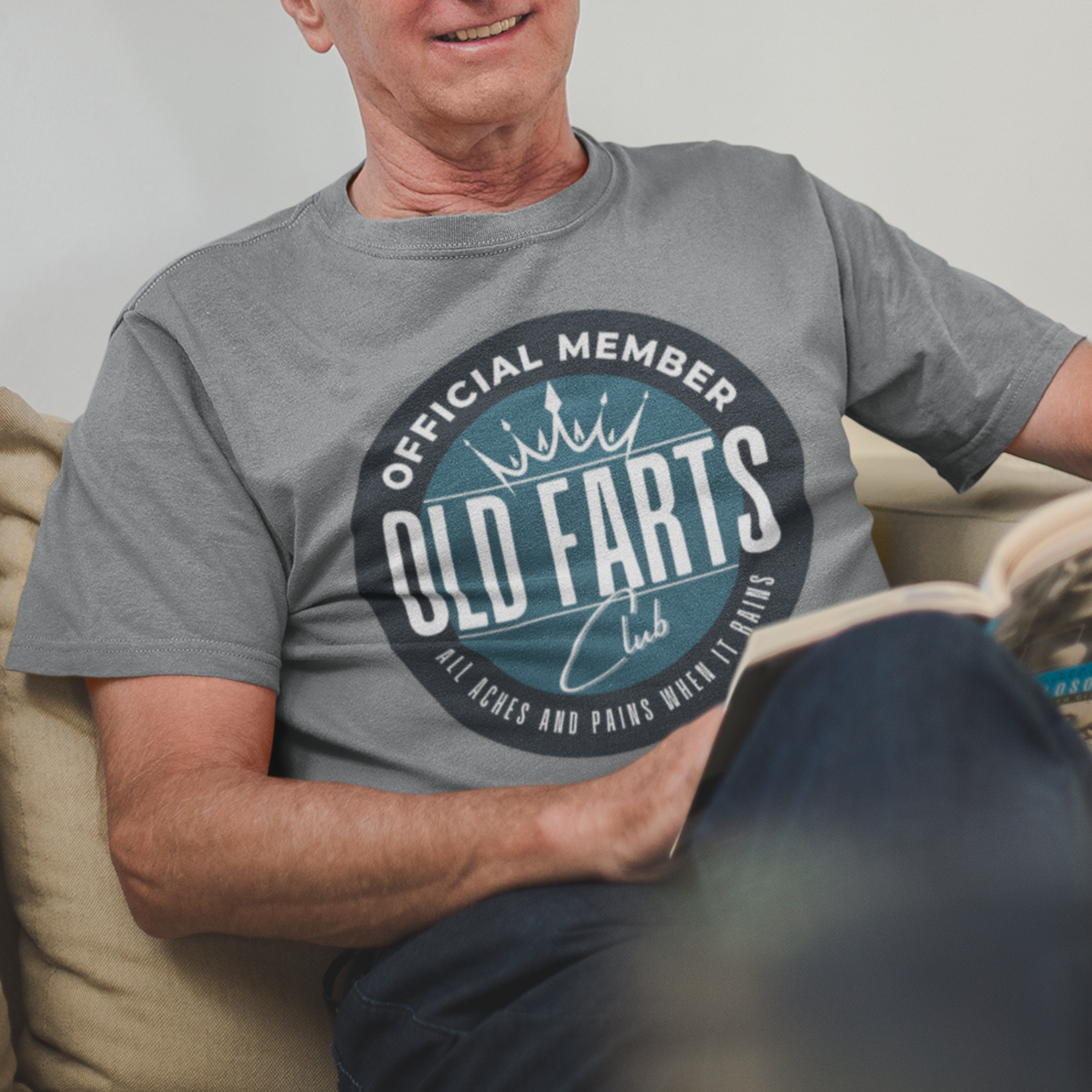 Gray tee featuring a blue-green insignia that reads Official Member Old Farts Club All Aches and Pains When it Rains