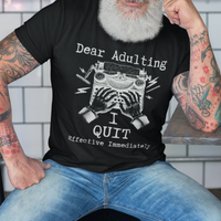 Black t-shirt featuring a man's hand typing out his resignation letter to Adulting on an old typewriter