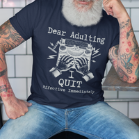 Navy blue t-shirt featuring a man's hand typing out his resignation letter to Adulting on an old typewriter