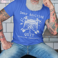 Royal blue t-shirt featuring a man's hand typing out his resignation letter to Adulting on an old typewriter