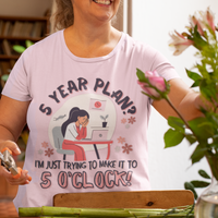 Pink t-shirt featuring an overwhelmed worker with her head down in her laptop that reads, 5 Year Plan? I'm Just Trying to Make it to 5 O'clock.