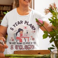 White t-shirt featuring an overwhelmed worker with her head down in her laptop that reads, 5 Year Plan? I'm Just Trying to Make it to 5 O'clock.