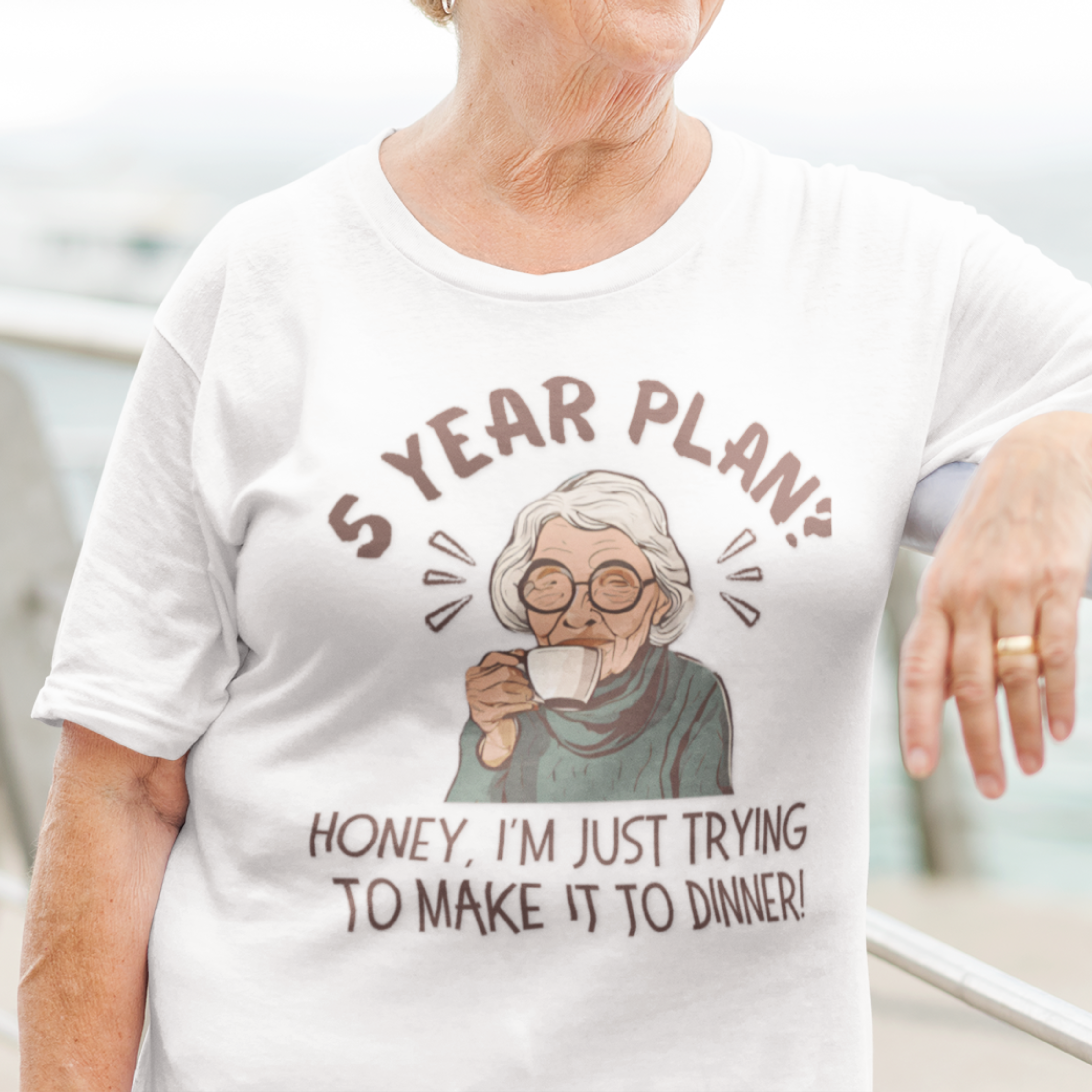 White t-shirt featuring a snarky old woman drinking her favorite hot beverage