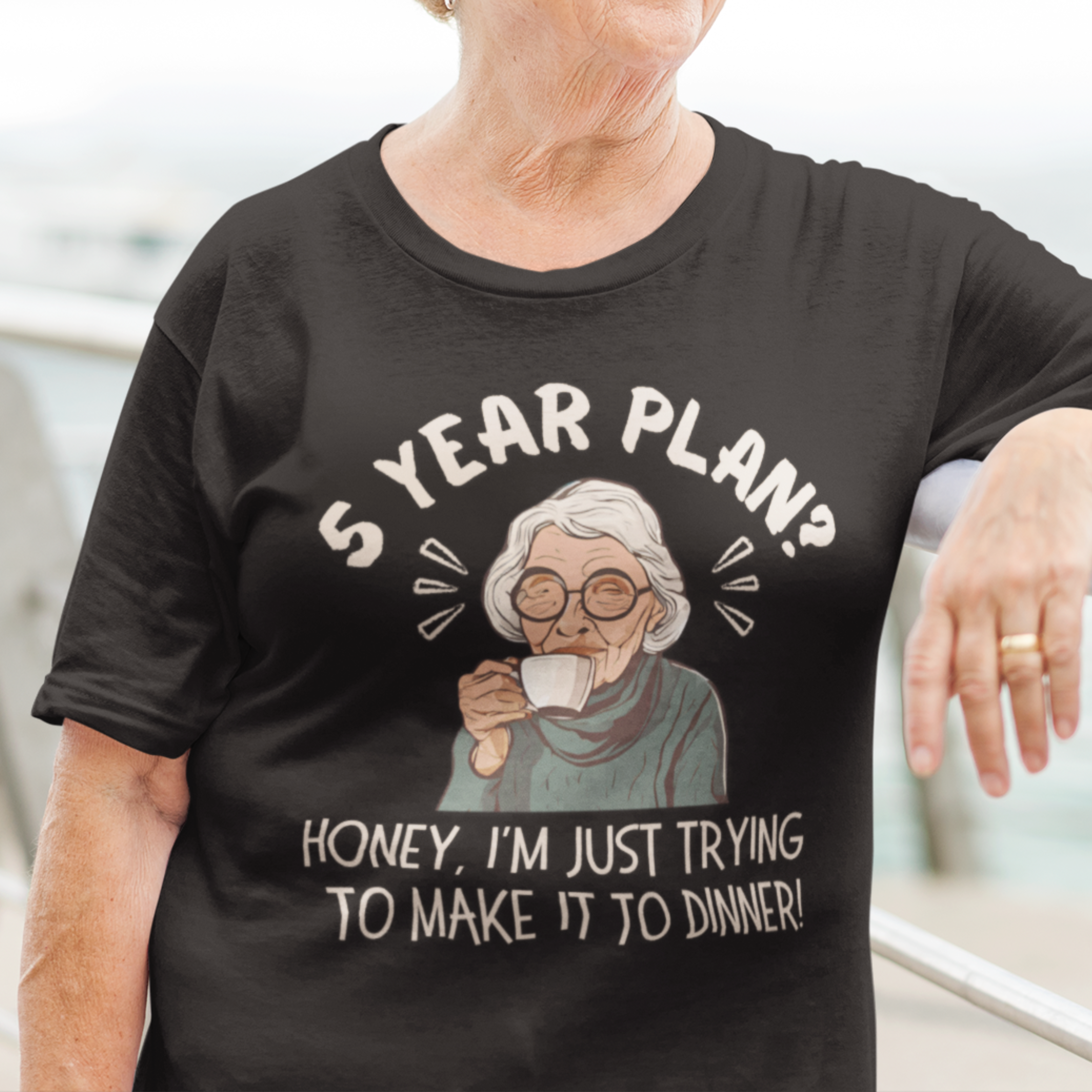 Black t-shirt featuring a snarky old woman drinking her favorite hot beverage